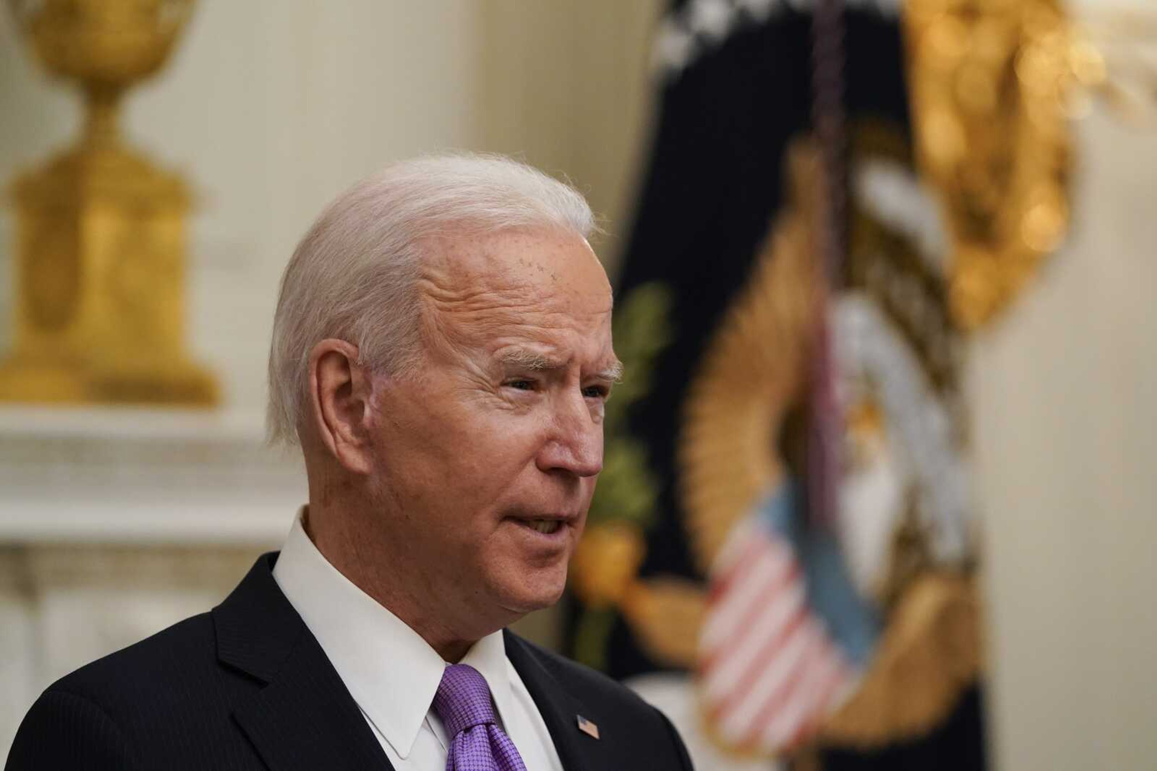 President Joe Biden speaks about the coronavirus Thursday in the State Dinning Room of the White House in Washington.