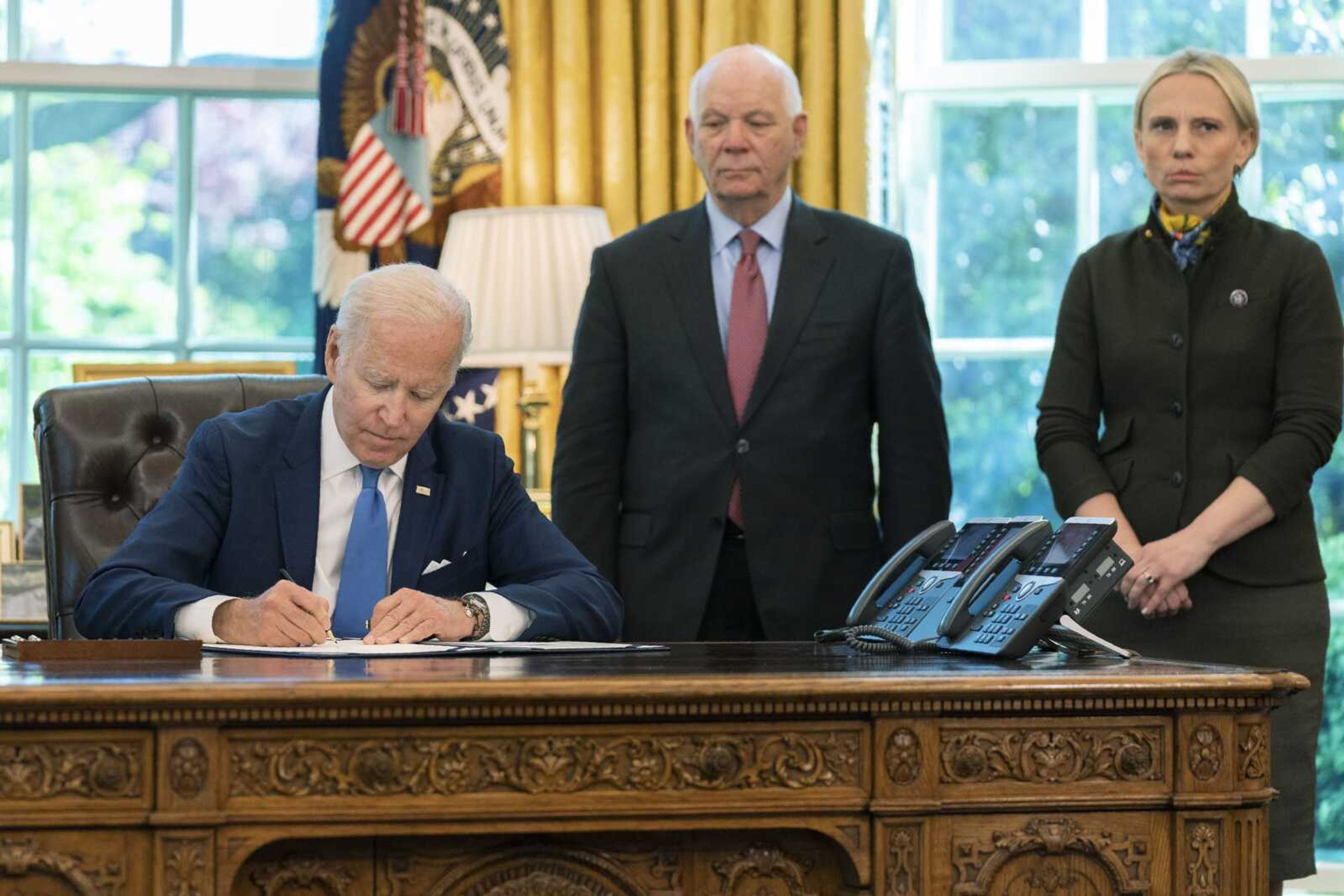 FILE - President Joe Biden signs the Ukraine Democracy Defense Lend-Lease Act of 2022 in the Oval Office of the White House, Monday, May 9, 2022, in Washington. Witnessing the signing are Ukraine-born Rep. Victoria Spartz, R-Ind., right, and Sen. Ben Cardin, D-Md. (AP Photo/Manuel Balce Ceneta, File)