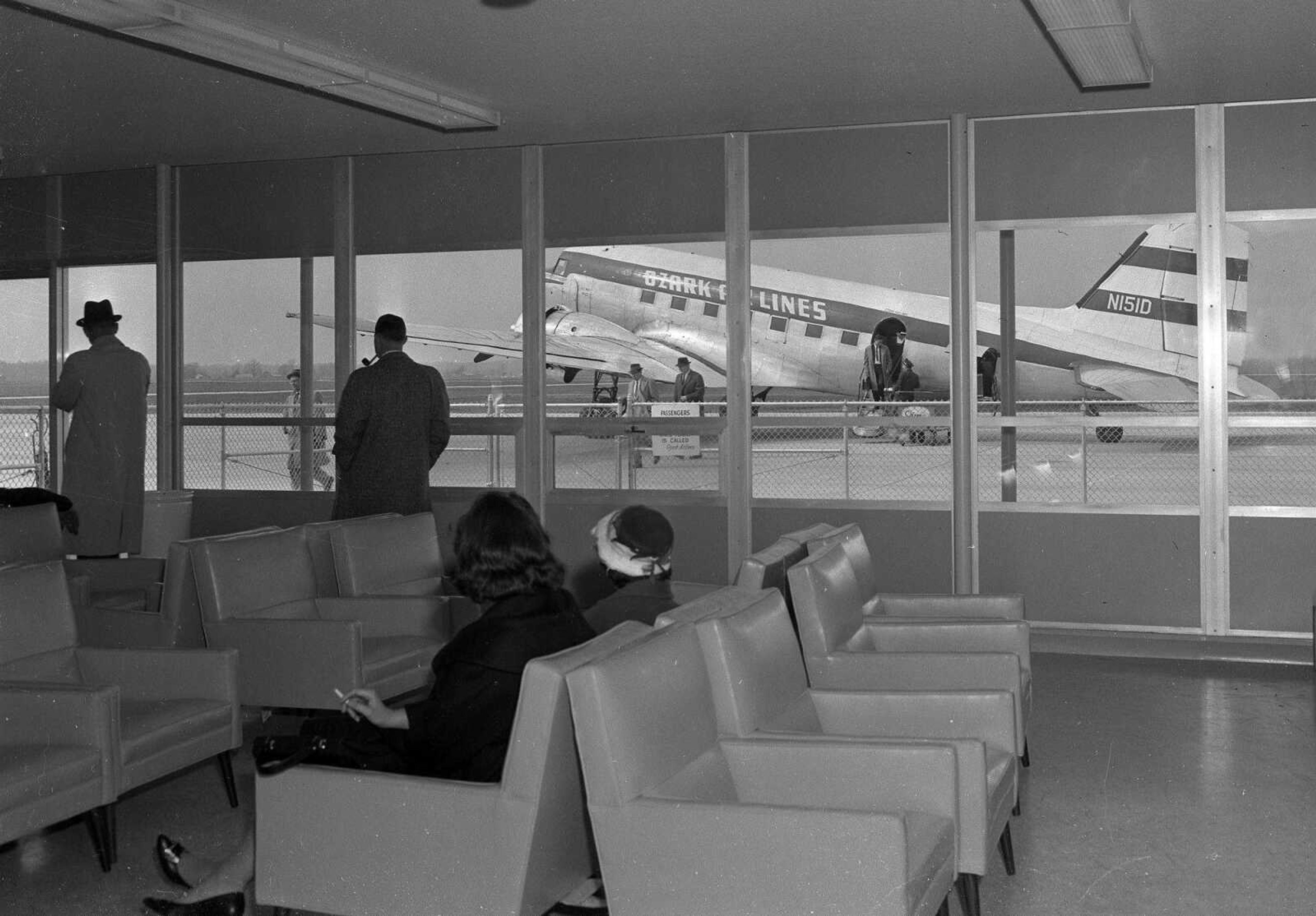 Southeast Missourian archive
Visitors in the waiting room at the Cape Girardeau Municipal Airport watch passengers disembark from an Ozark Air Lines flight in this undated file photo.