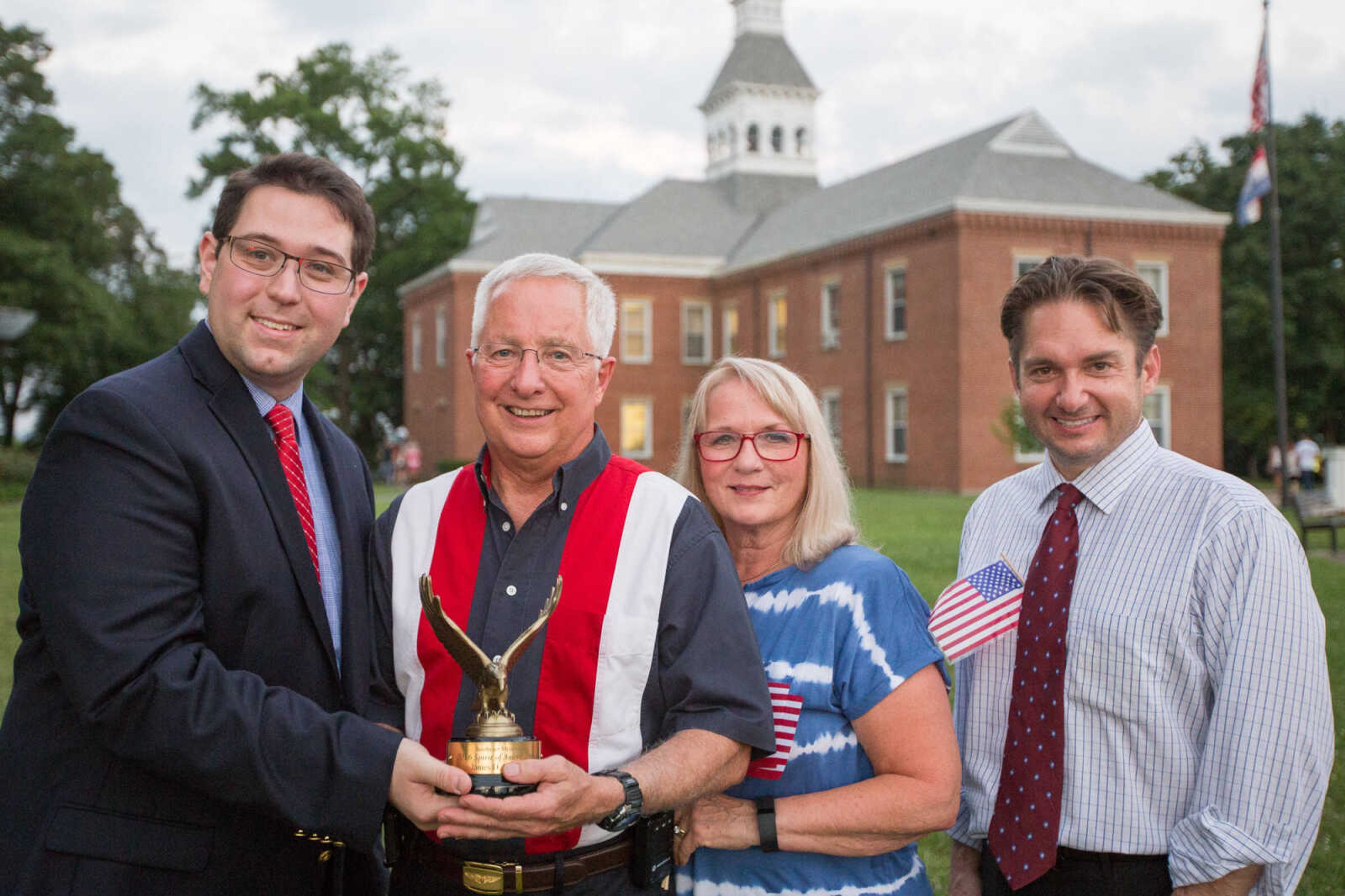 GLENN LANDBERG ~ glandberg@semissourian.com

Lucas Presson, left, general manager of rustmedia, and Jon K. Rust, right, publisher of the Southeast Missourian and co-president of Rust Communications, stand with James D. Bollinger and his wife after recieving the 2016 Spirit of America award Monday, July 4, 2016 at the Common Pleas Courthouse in Cape Girardeau.