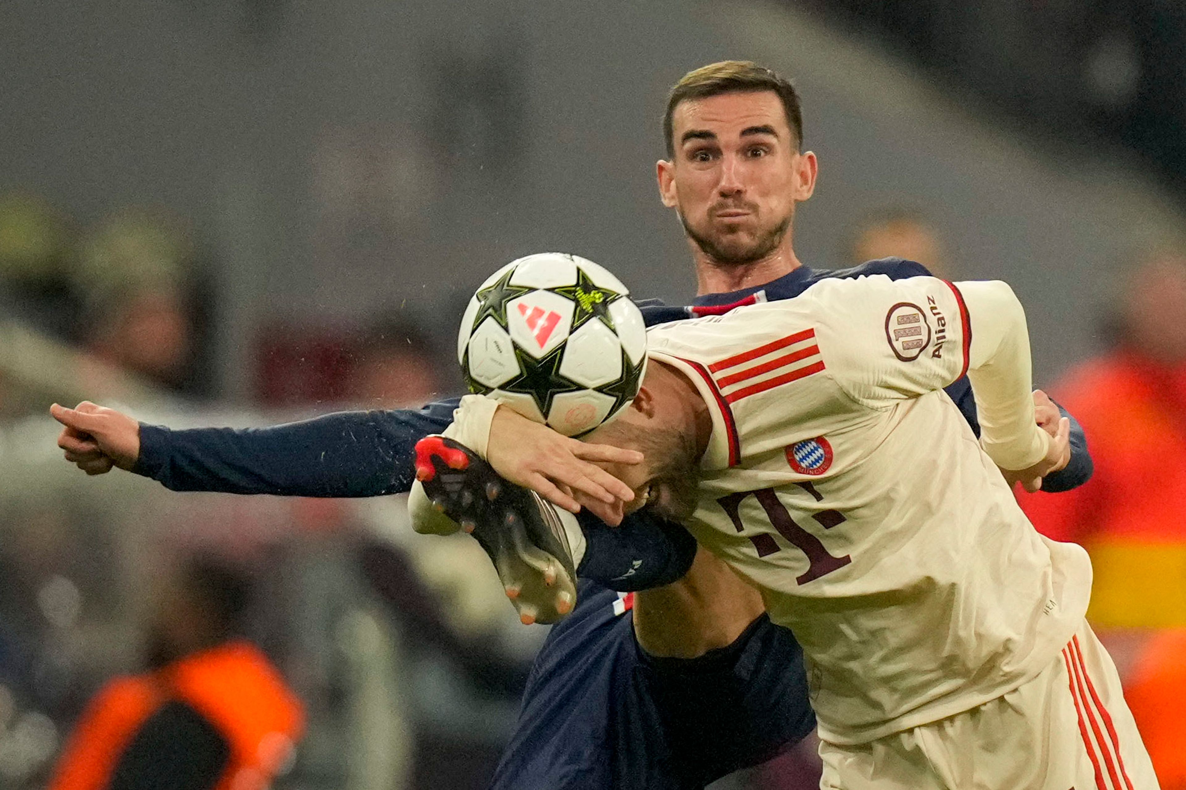 Bayern's Konrad Laimer, front, duels for the ball with PSG's Fabian Ruiz during the Champions League opening phase soccer match between FC Bayern and Paris Saint Germain, at the Allianz Arena in Munich, Germany, Tuesday, Nov. 26, 2024.(AP Photo/Matthias Schrader)