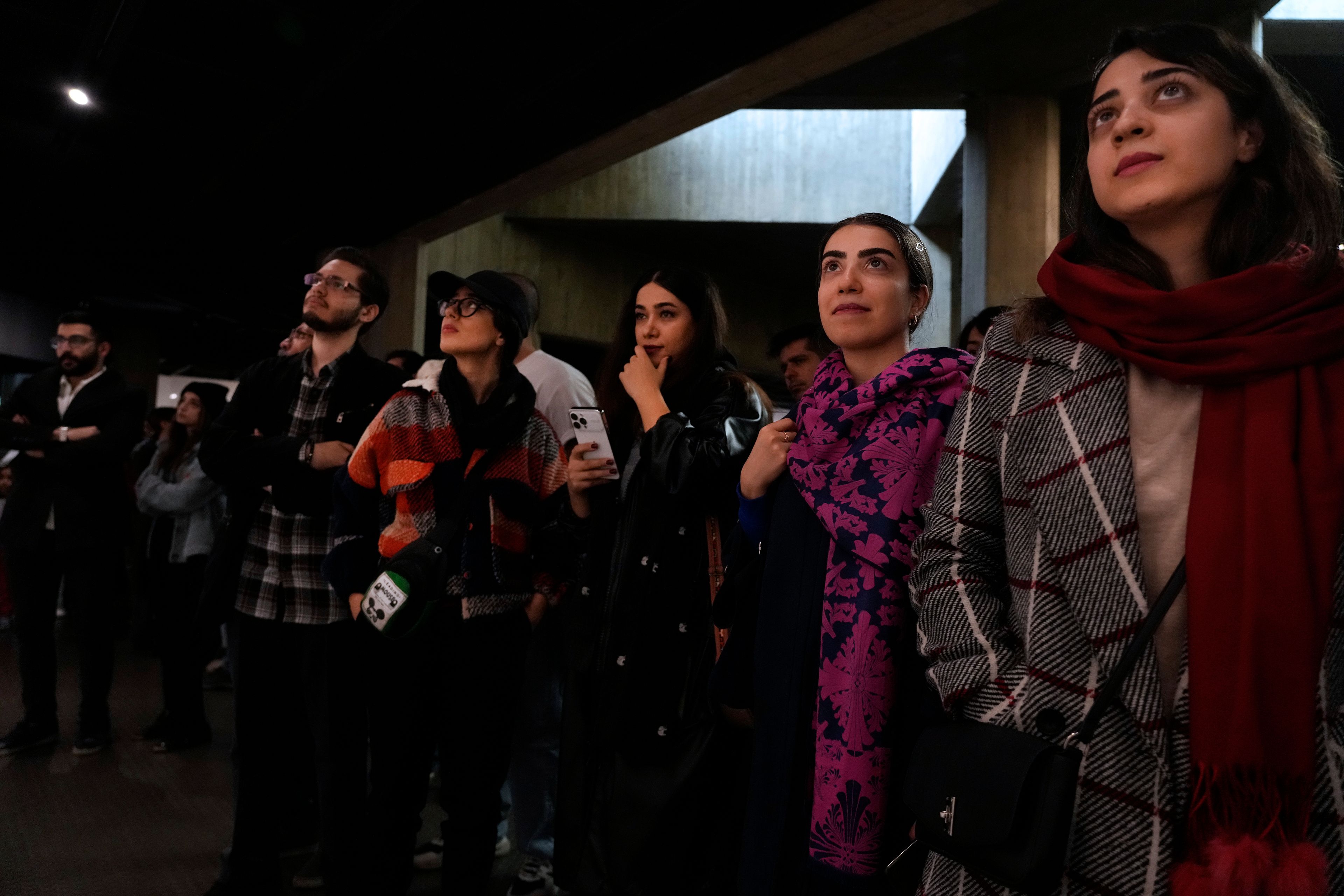 People visit an exhibition titled Eye to Eye which showcases over 120 works by modern world artists as well as Iranian painters at Tehran Museum of Contemporary Art, in Tehran, Thursday, Nov. 21, 2024. (AP Photo/Vahid Salemi)