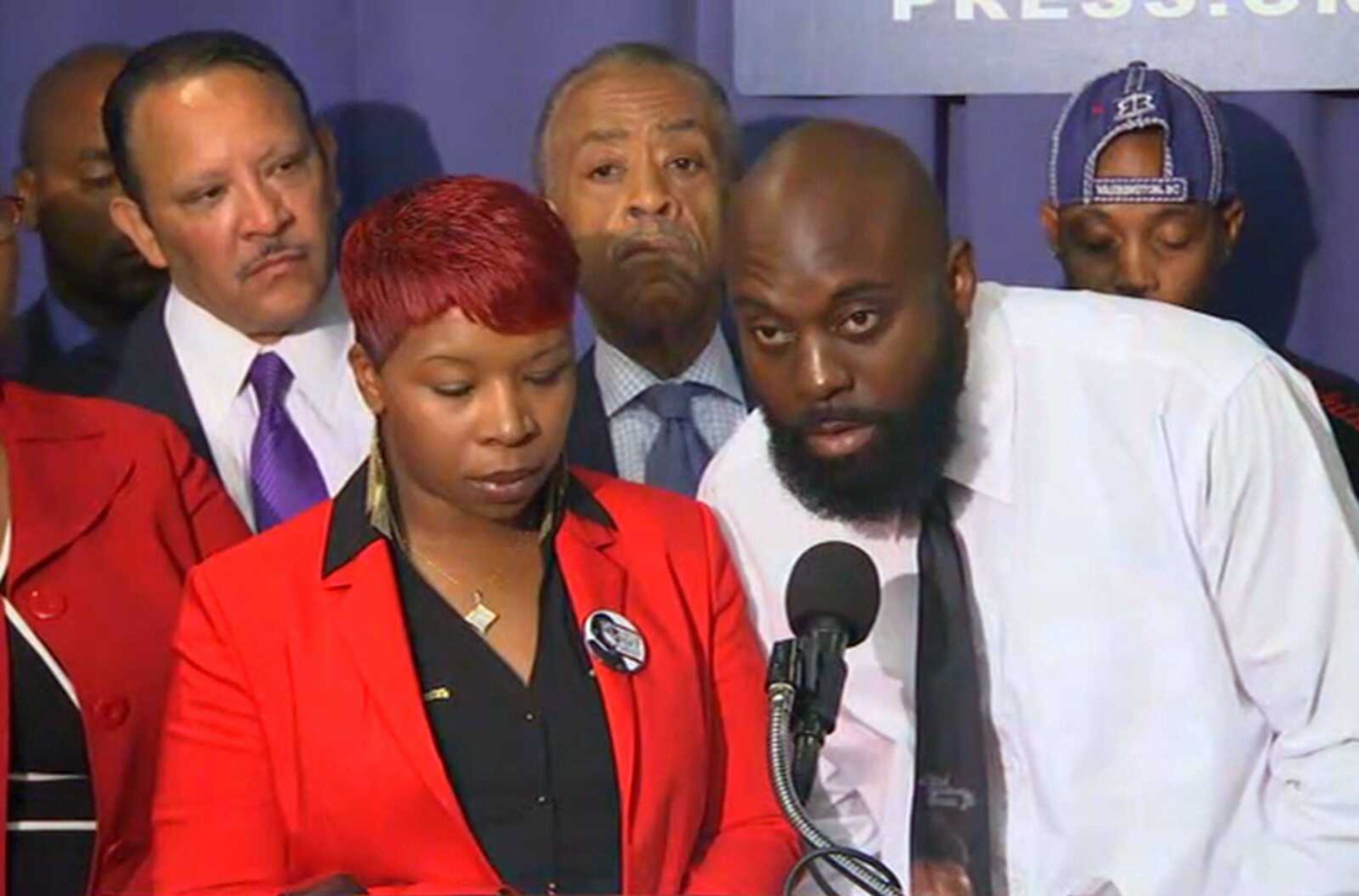 Michael Brown's parents, Lesley McSpadden and Michael Brown Sr., speak at a news conference Thursday with civil rights leaders at the National Press Club in Washington. Brown's parents were joined by Eric Garner's mother in calling for federal investigations into the death of their sons, two unarmed black men who were killed by police. (Associated Press)