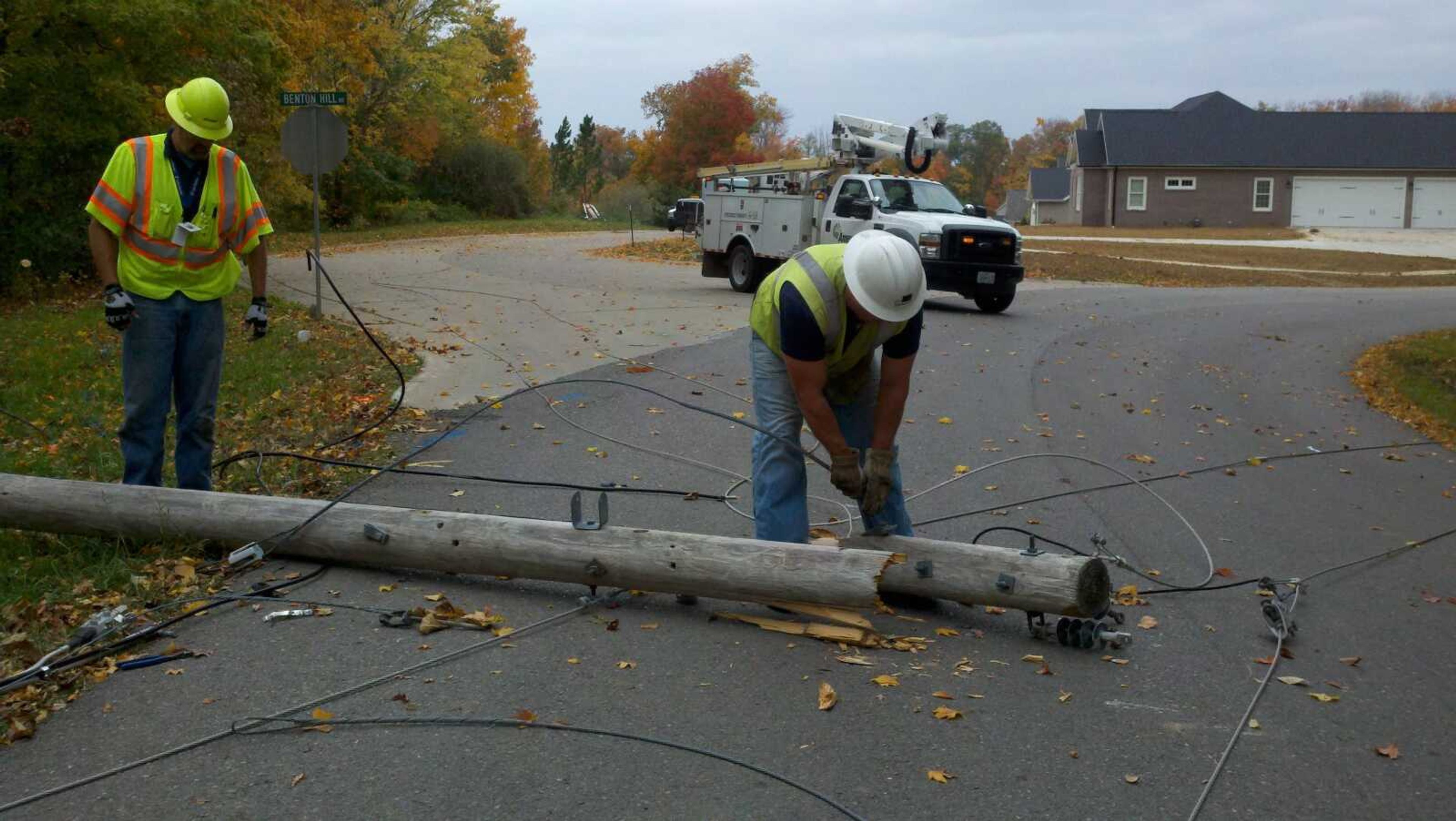 A utility crew works on downed power lines on County Road 206 near Cape Girardeau on Wednesday, Oct. 17. The lines were downed by high winds moving through the area, and caused the closure of the road from Bloomfield Road to Cobblestone Court for several hours. (Laura Simon)