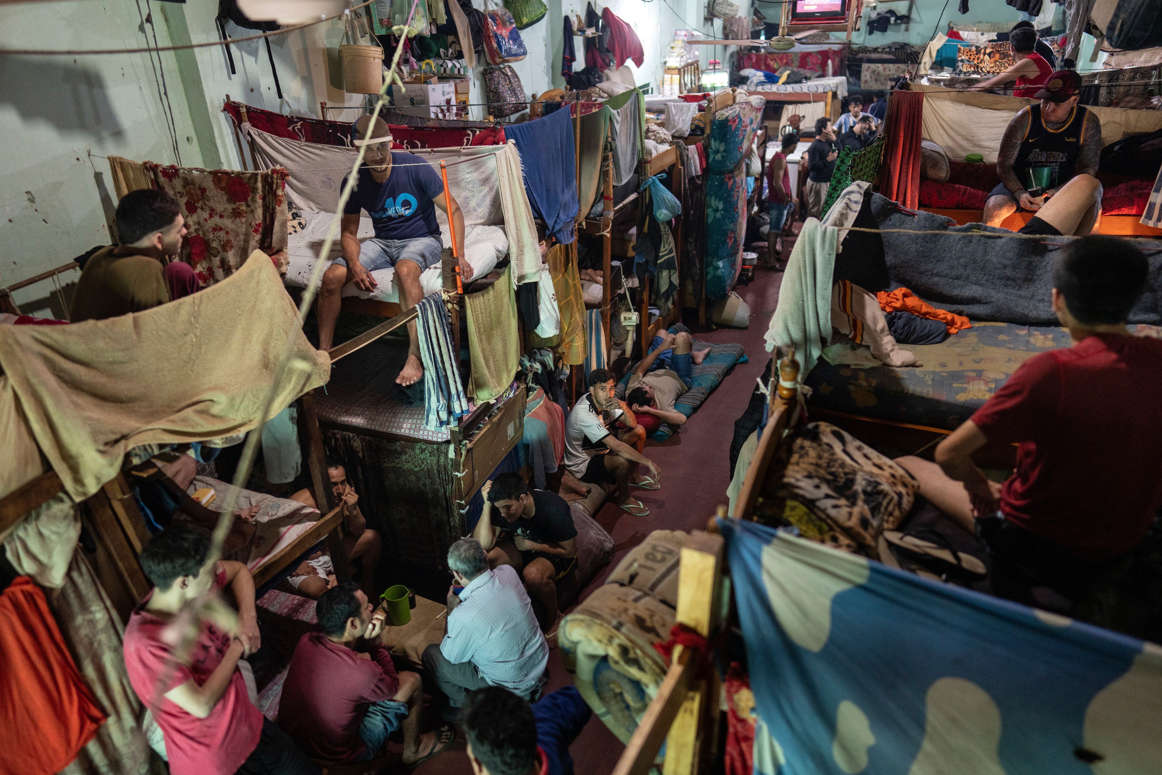 Prisoners sit in their cell block at the Regional Penitentiary in Villarica, Paraguay, Sunday, Sept. 1, 2024. (AP Photo/Rodrigo Abd)