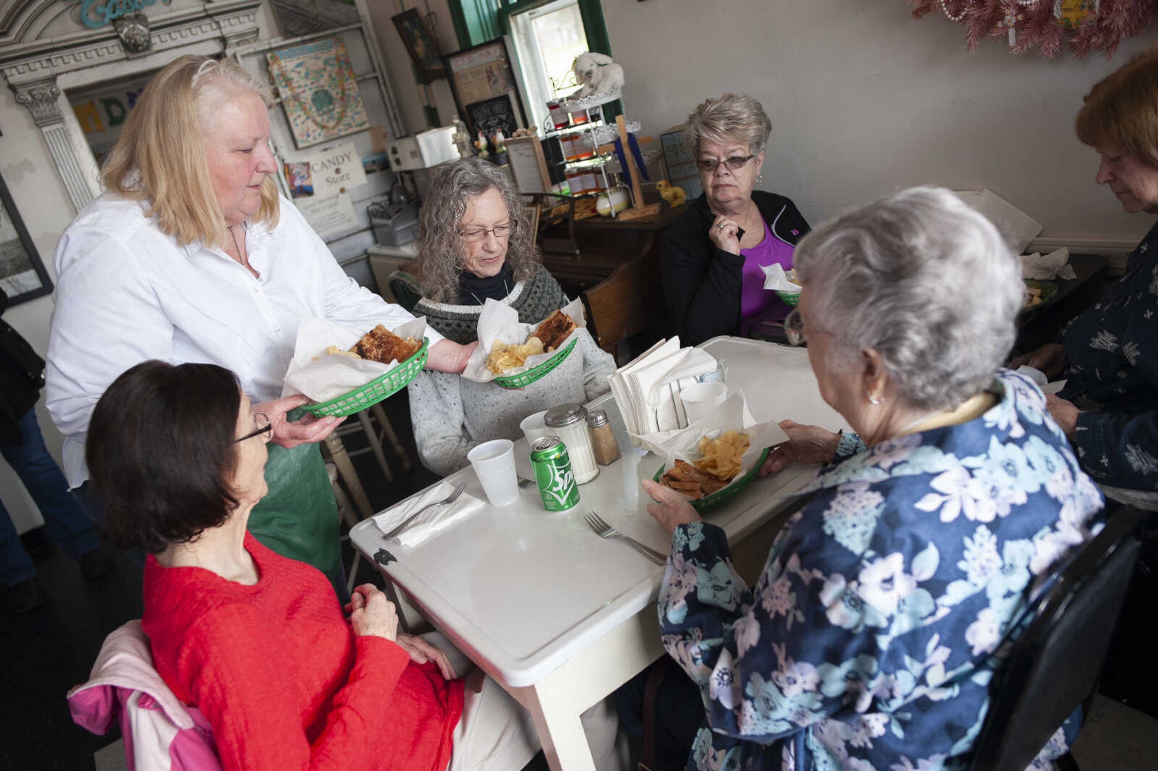 Sharon Penrod waits on customers (counterclockwise from woman in purple by wall) Carol Kluender, Charlie Meeks, Carol Barron, Ruth Graham and Sue Baugher, all of Perryville, Missouri, on Wednesday, March 11, 2020, at The Pie Safe Bakery & Cafe in Pocahontas.