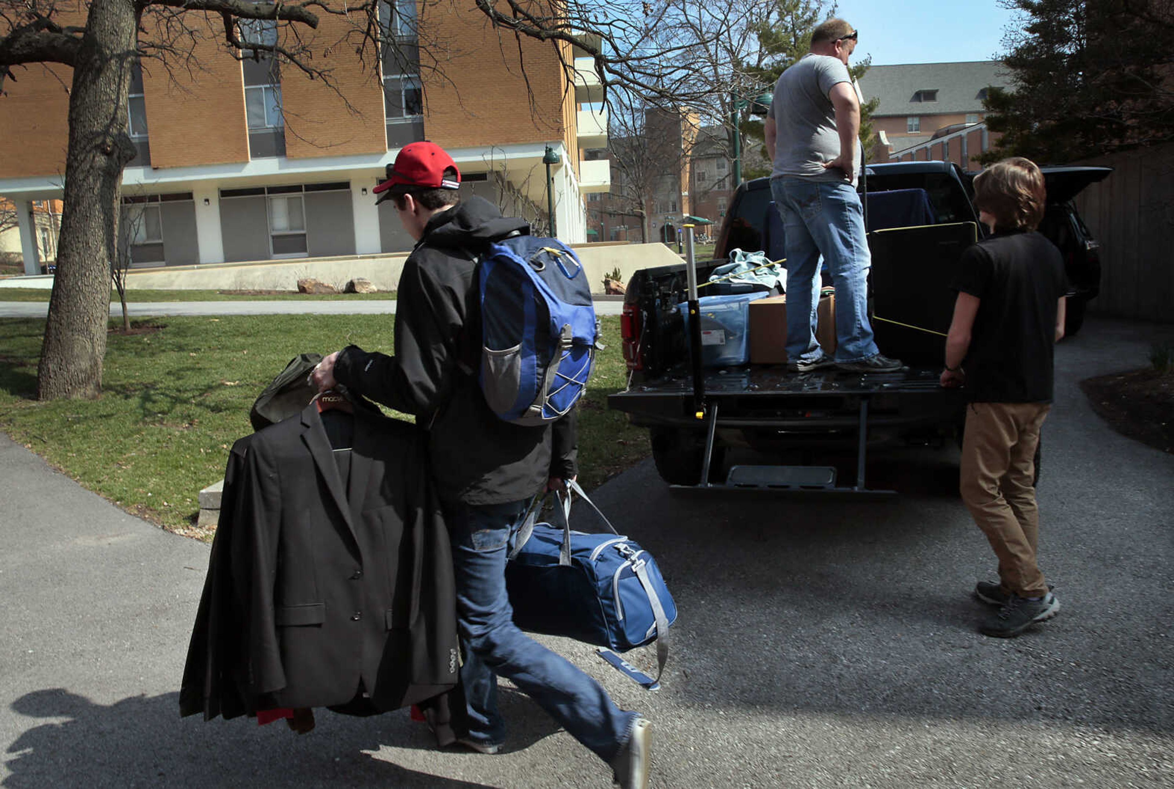 A Washington University engineering student, who declined identification, removes his belongings from his dormitory at the school in St. Louis on Wednesday, March 11, 2020, to move back home to Ballwin, Mo. A few other students on the South Danforth campus were doing the same as dorms were set to shutter Sunday from fear of the coronavirus. Students on spring break were told not to return to campus and to continue their classes online. 