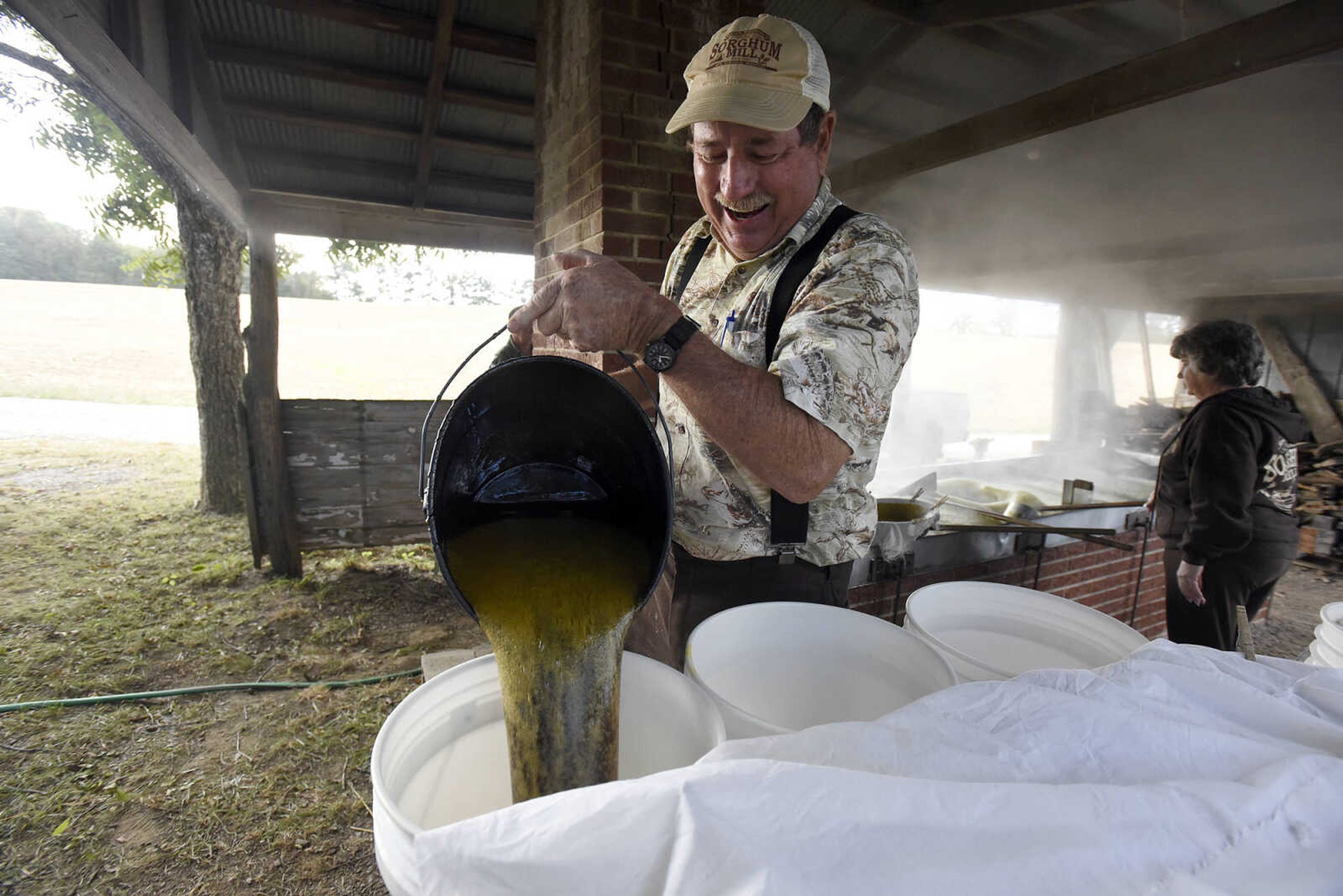 LAURA SIMON ~ lsimon@semissourian.com

Ralph Enderle pours hot sorghum into buckets at his New Hamburg, Missouri home on Monday, Oct. 10, 2016.