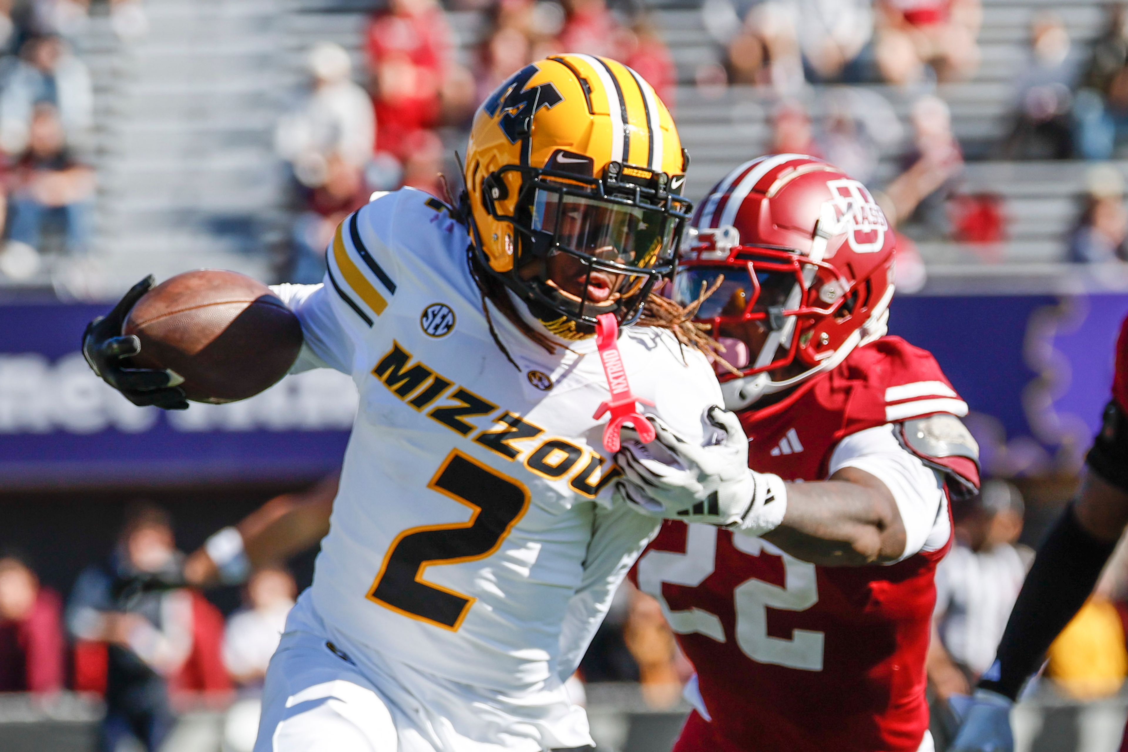 Missouri wide receiver Marquis Johnson (2) tries to evade the grasp of Massachusetts linebacker Gerrell Johnson (22) during the first half of an NCAA football game, Saturday, Oct. 12, 2024, in Amherst, Mass. (AP Photo/Greg M. Cooper)