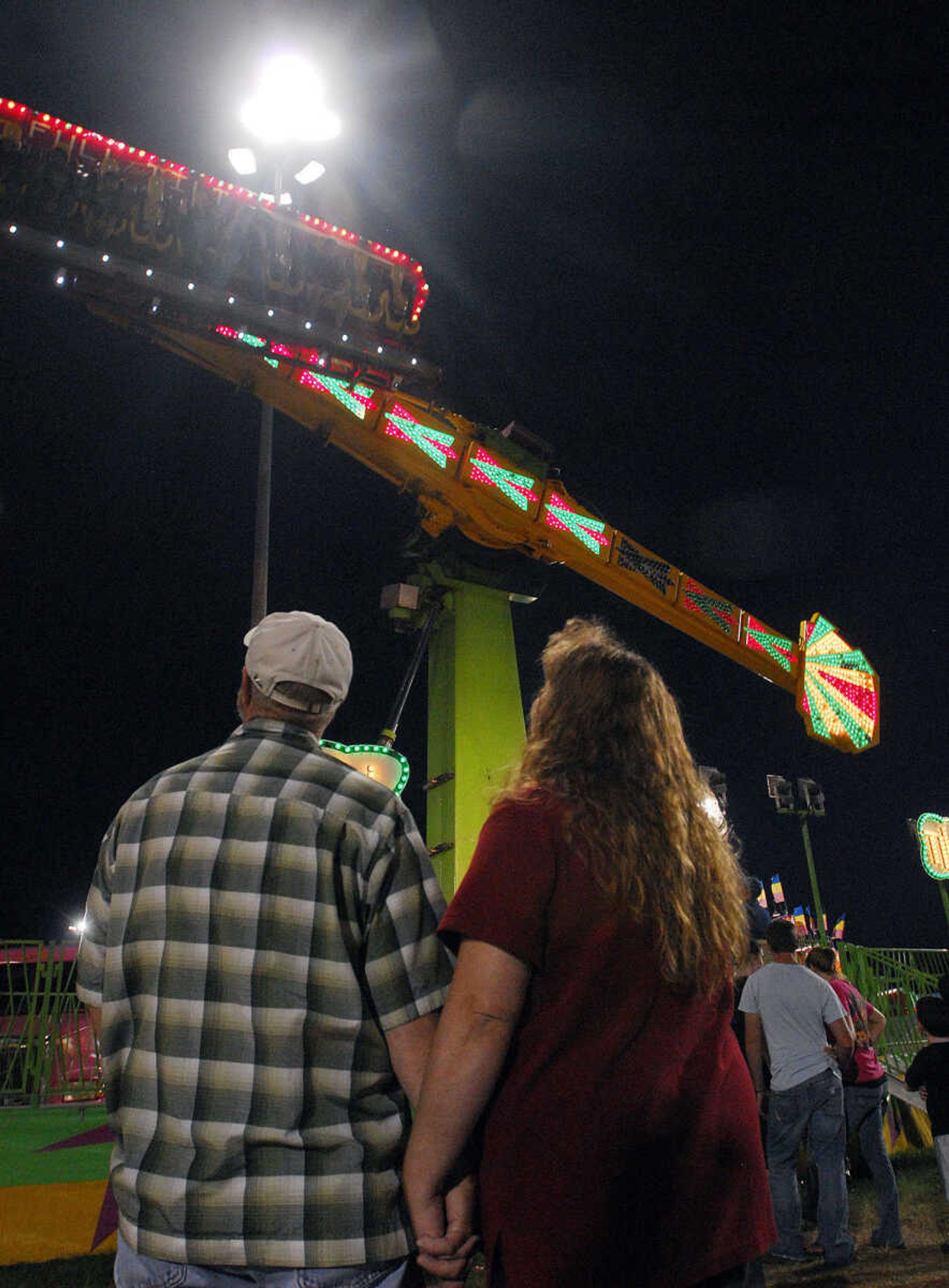 LAURA SIMON~lsimon@semissourian.com
A couple watches the Full Tilt ride Thursday, September 16, 2010 during the 155th Annual SEMO District Fair.