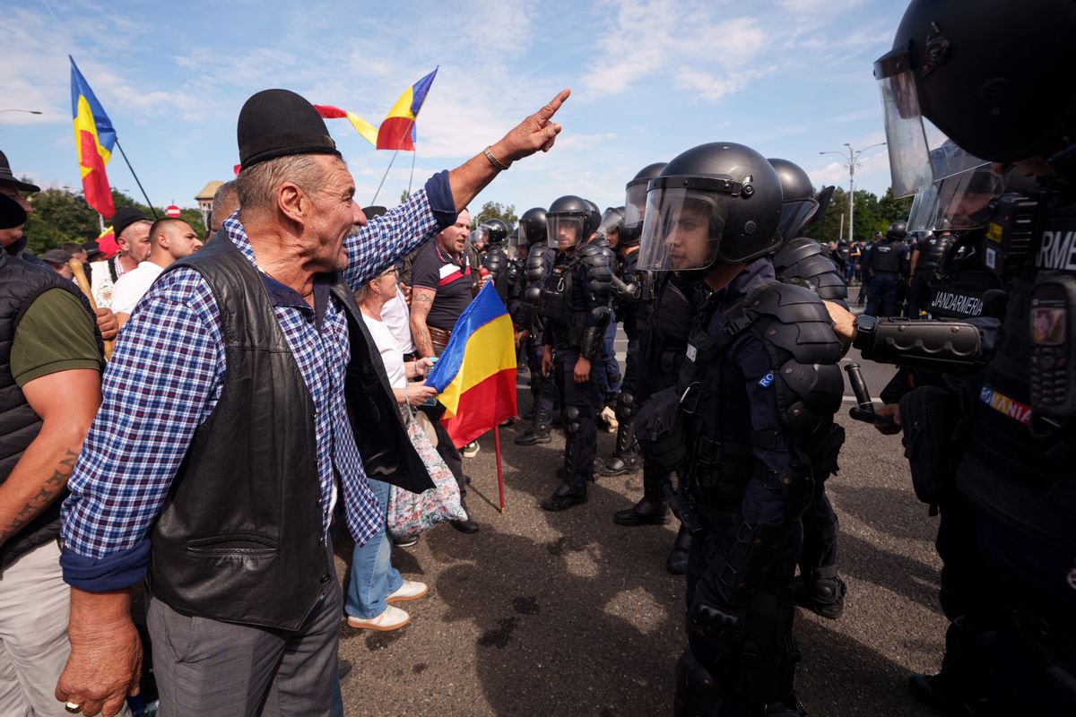 Romanian farmers protest export restrictions outside government headquarters in Bucharest; riot police spray tear gas as scuffles erupt
