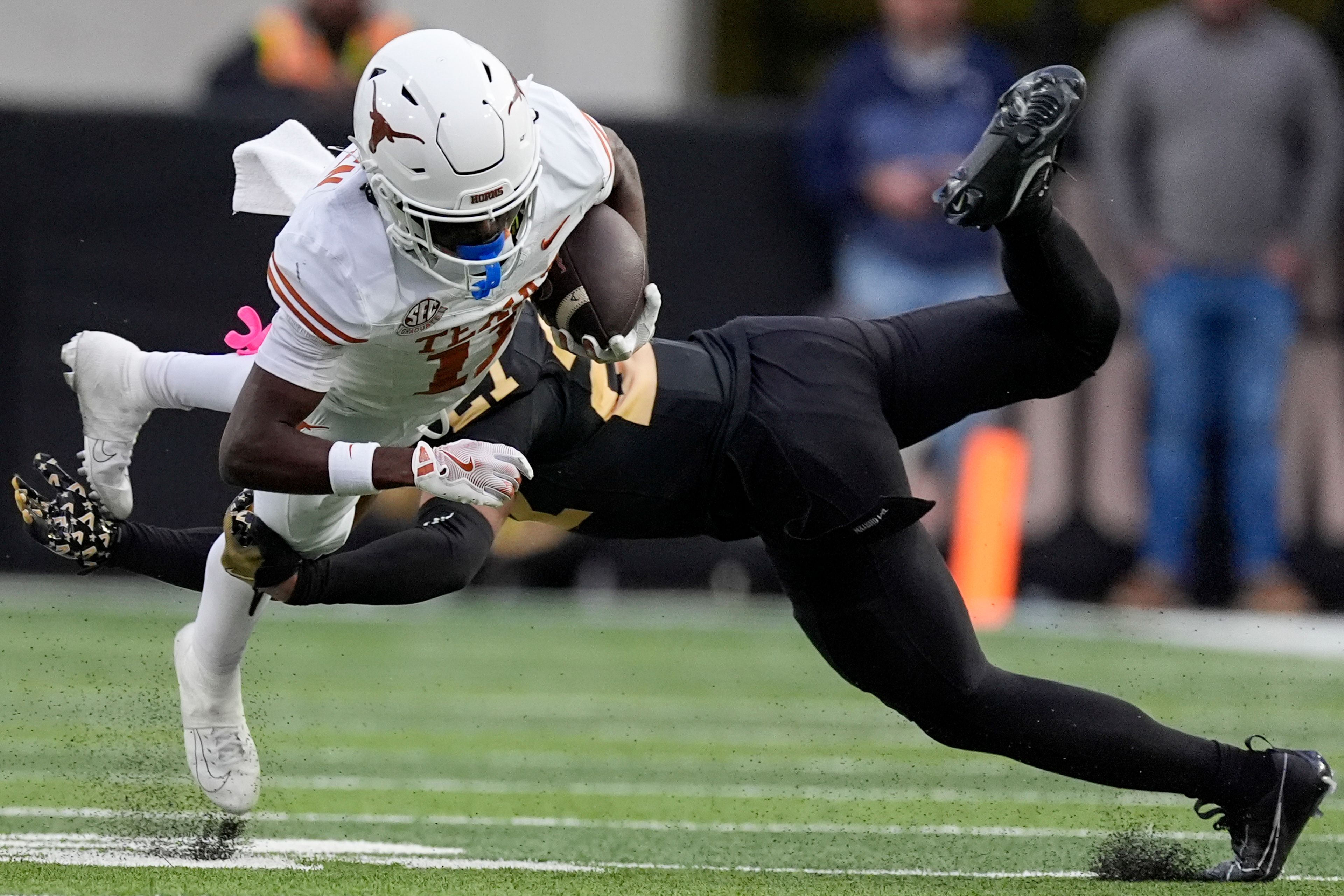 Texas wide receiver Silas Bolden, left, dives extra yards past Vanderbilt safety Dontae Carter, right, during the second half of an NCAA college football game Saturday, Oct. 26, 2024, in Nashville, Tenn. (AP Photo/George Walker IV)