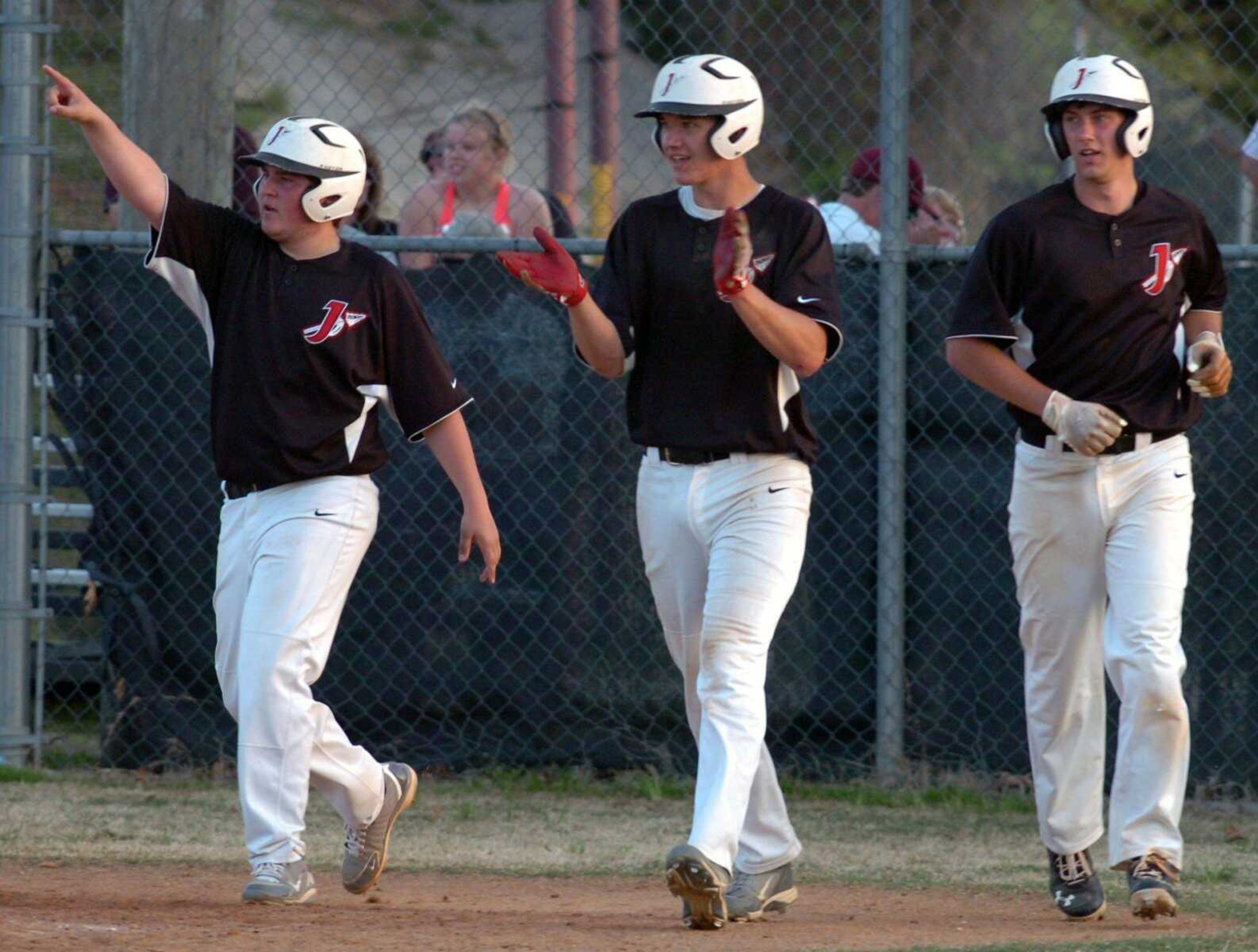 From left, Jackson&#8217;s Collin Herzog, Laban Petzoldt and Kyle James celebrate after Petzoldt and James scored on Cody Harris&#8217; double in the top of the 14th inning Wednesday. The hit broke a 1-1- tie. (Brian Rosener ~ Daily American Republic)