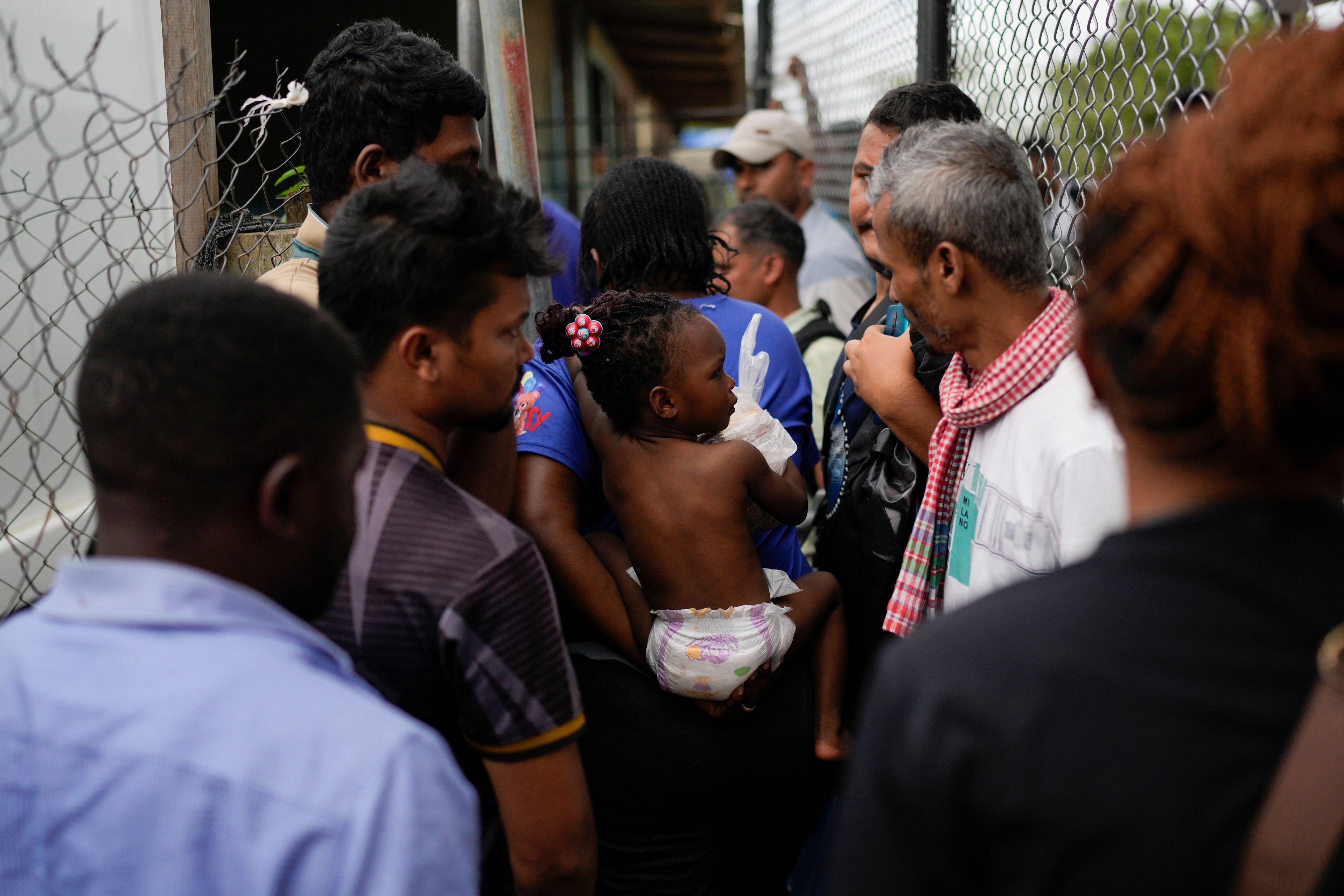 Dorcas Many carries her daughter at a camp for migrants who walked across the Darien Gap in hopes of reaching the U.S., in Lajas Blancas, Panama, Thursday, Sept. 26, 2024. (AP Photo/Matias Delacroix)