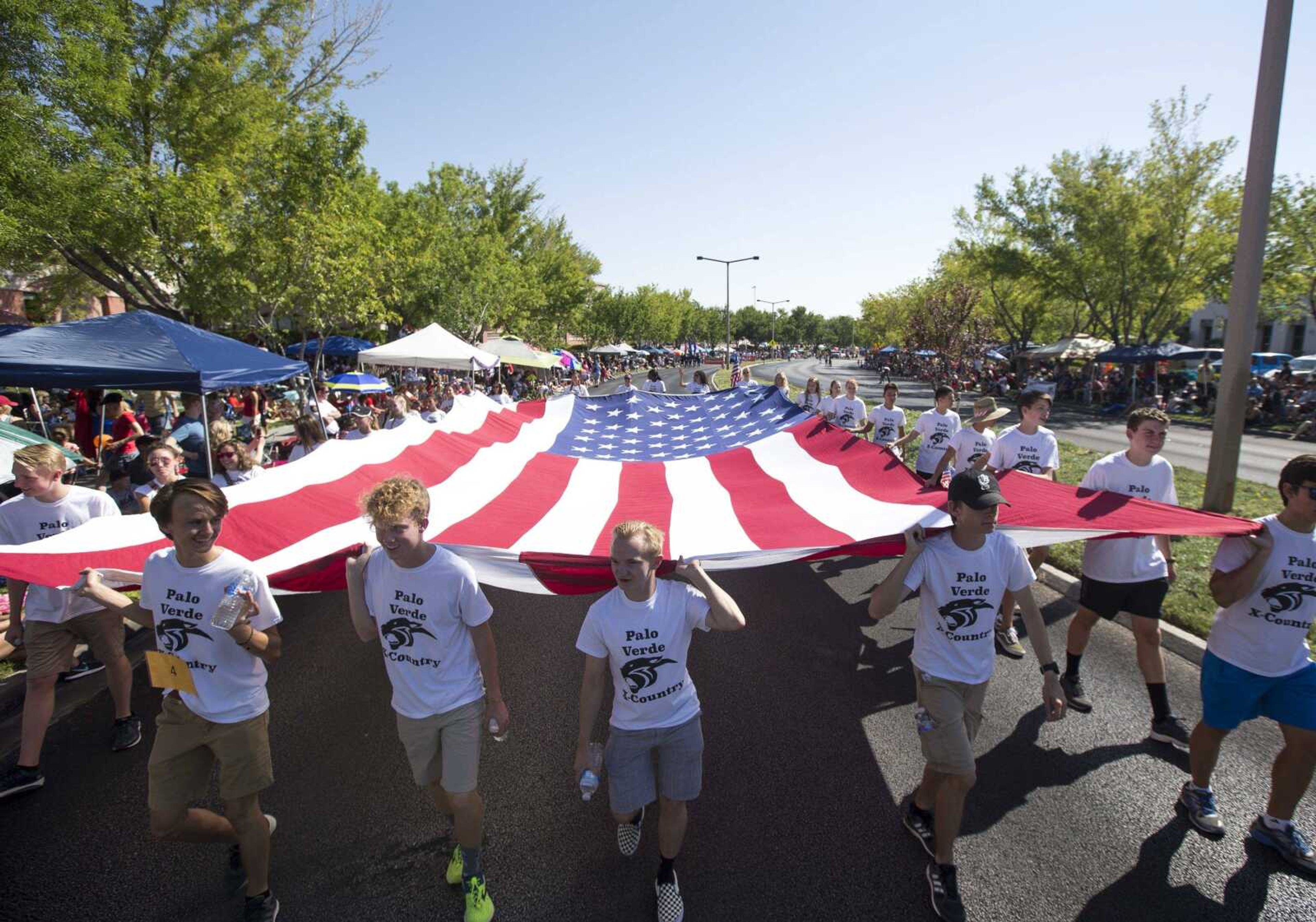 Members of the Palo Verde High School track team march Wednesday with a giant American flag during the Summerlin Council Patriotic Parade in Las Vegas.