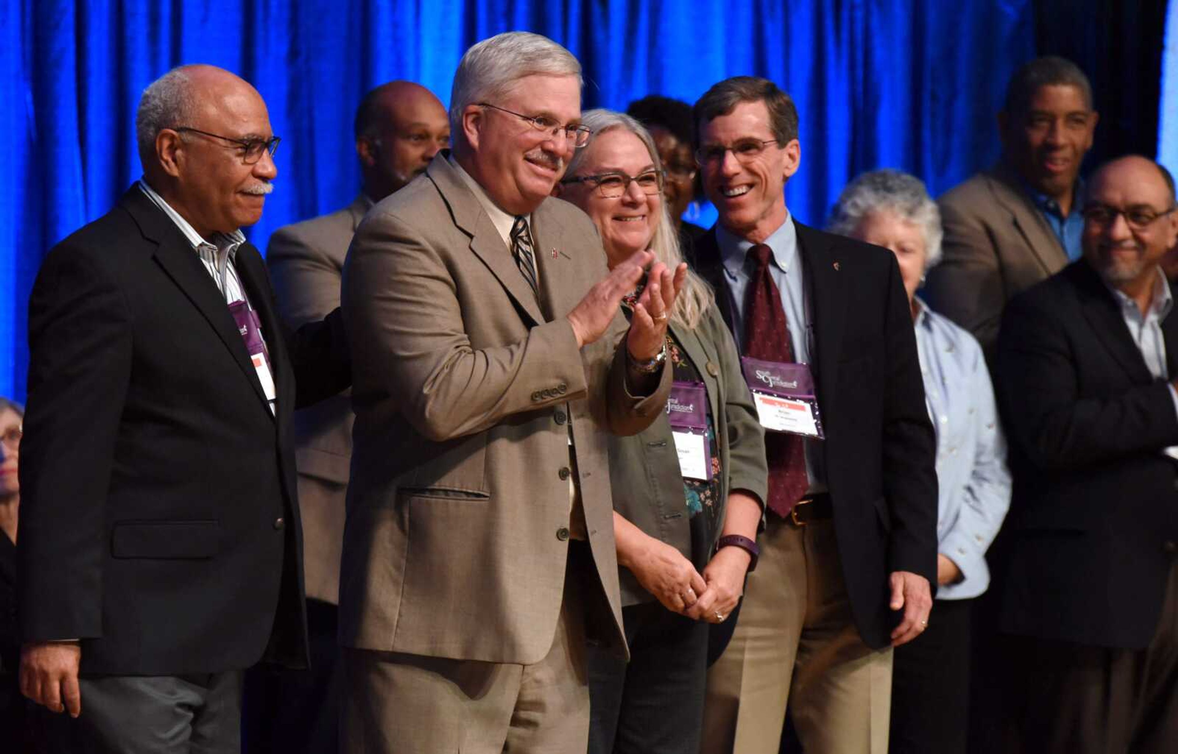 The Rev. Robert  Farr, clapping, center, acknowledges his reappointment Thursday, Nov. 3, as Missouri bishop of the United Methodist Church. Farr became bishop six years ago.