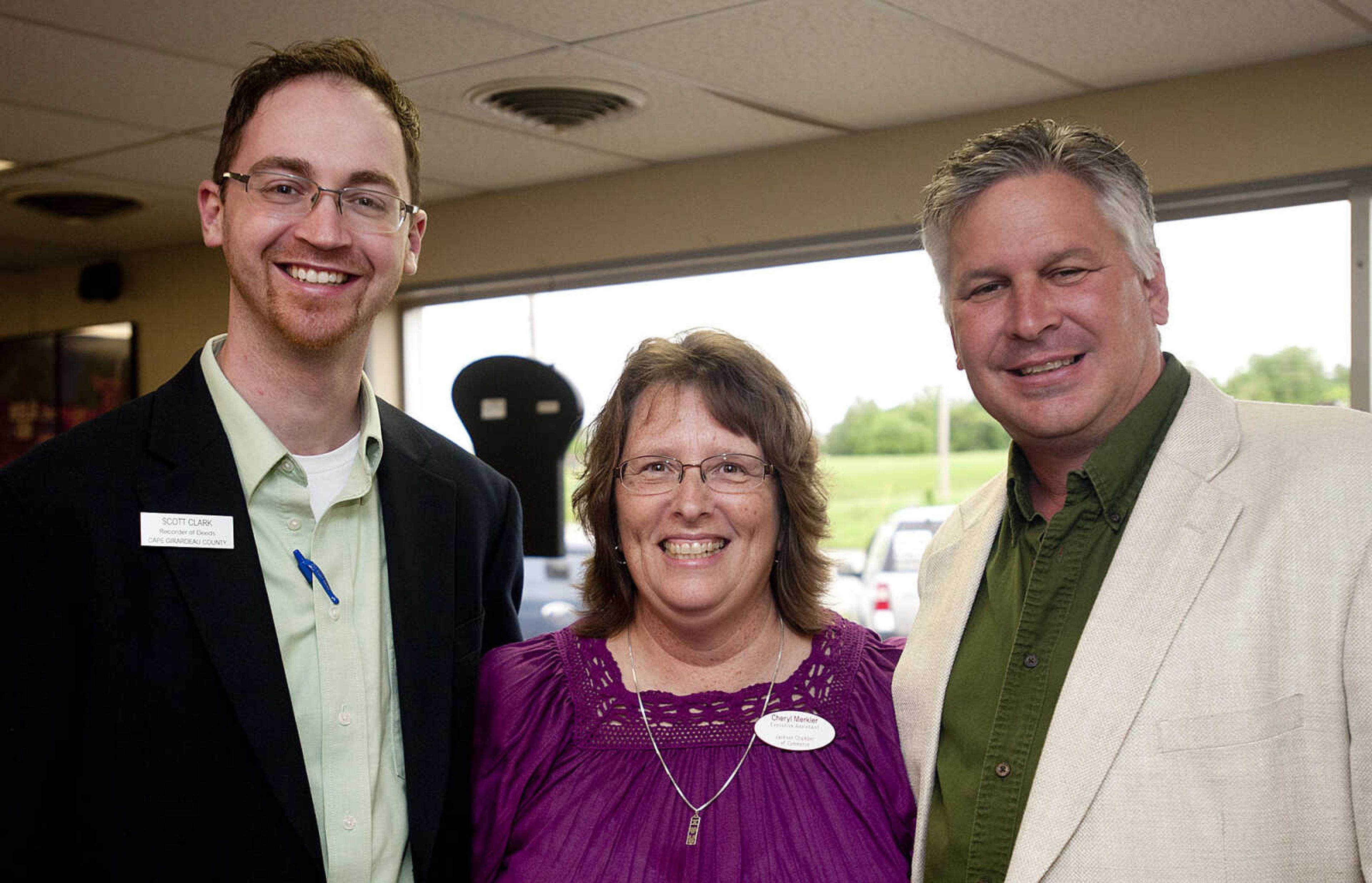 Scott R. Clark, left, Cape Girardeau County Recorder of Deeds, Cheryl Merkler, Jackson Area Chamber of Commerce, and Jim Fels, Sunbelt Environmental Services, during the Jackson Area Chamber of Commerce's After Hours event Tuesday, May 13,  at First Auto Credit in Jackson, Mo.