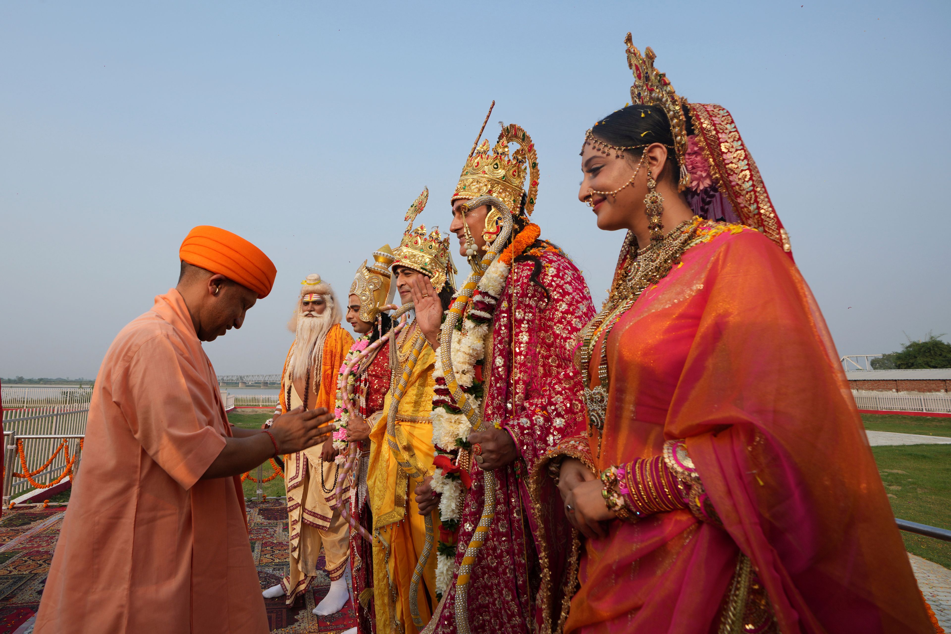 Yogi Adityanath, Chief Minister of the northern Indian state of Uttar Pradesh, offers prayers in front of actors playing Hindu god Rama, his wife Sita, and his brothers during Deepotsav celebrations on the eve of Diwali, in Ayodhya, India, Wednesday, Oct. 30, 2024. (AP Photo/Rajesh Kumar Singh)