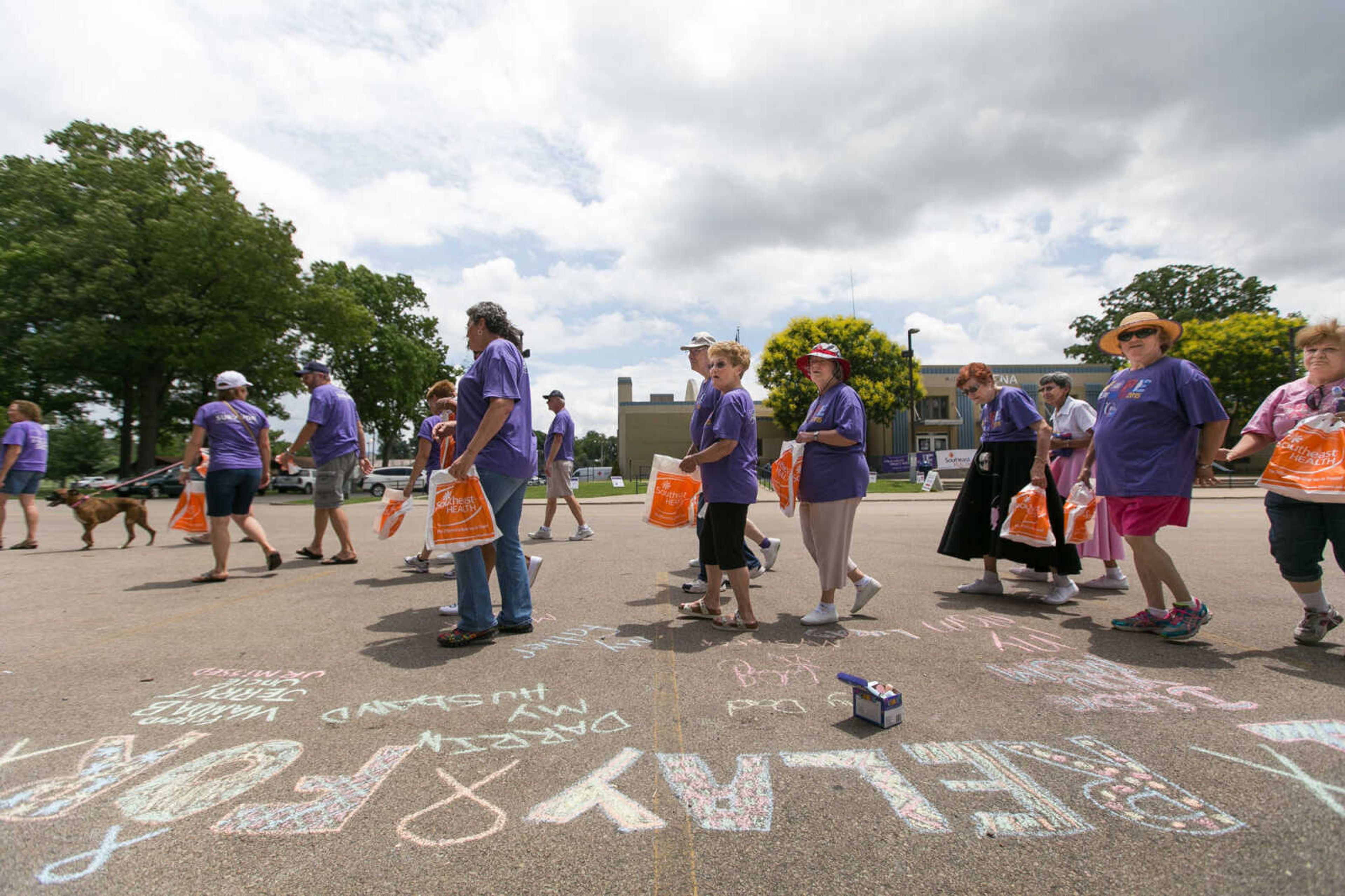 GLENN LANDBERG ~ glandberg@semissourian.com

Cancer survivors take the first walk around the track during the survivor's lap at the Relay for Life of Cape Girardeau County fundraiser at Arena Park, Saturday, June 13, 2015. Patrons could use chalk to show who they were walking for.