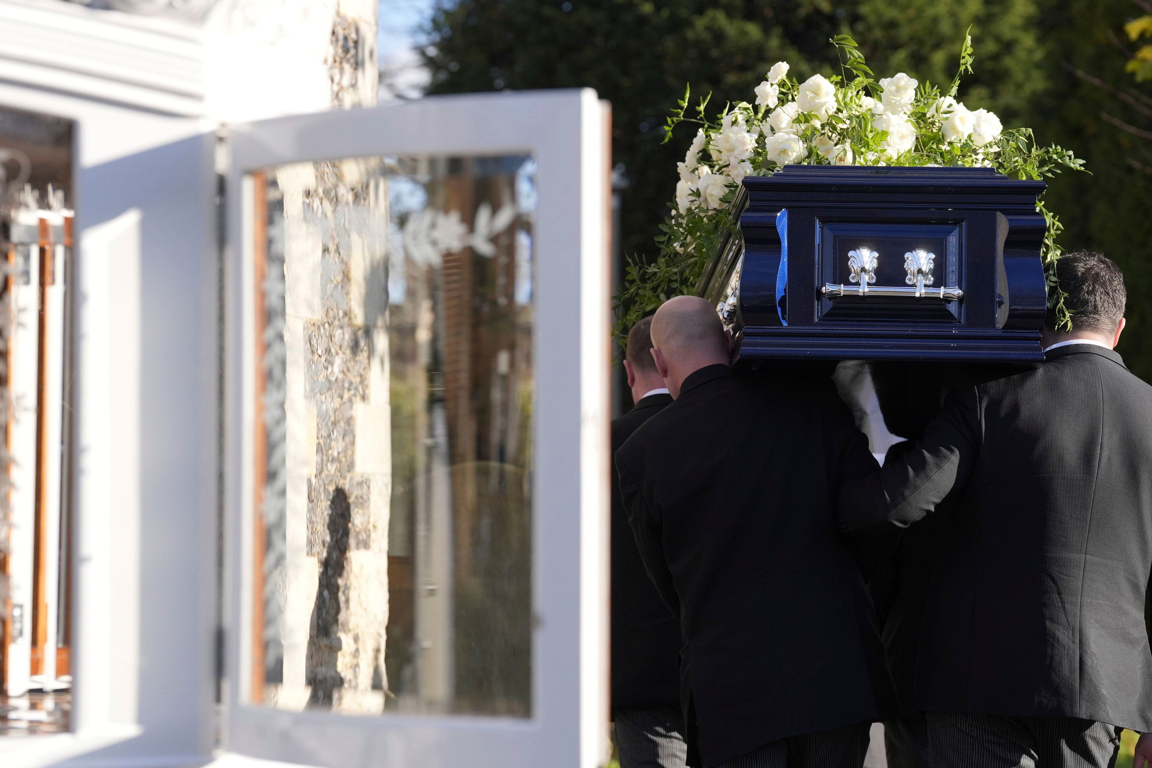 Liam Payne's coffin is carried into the funeral service for the One Direction singer at St Mary's Church in Amersham, Buckinghamshire, England, Wednesday Nov. 20, 2024. (Andrew Matthews/PA via AP)