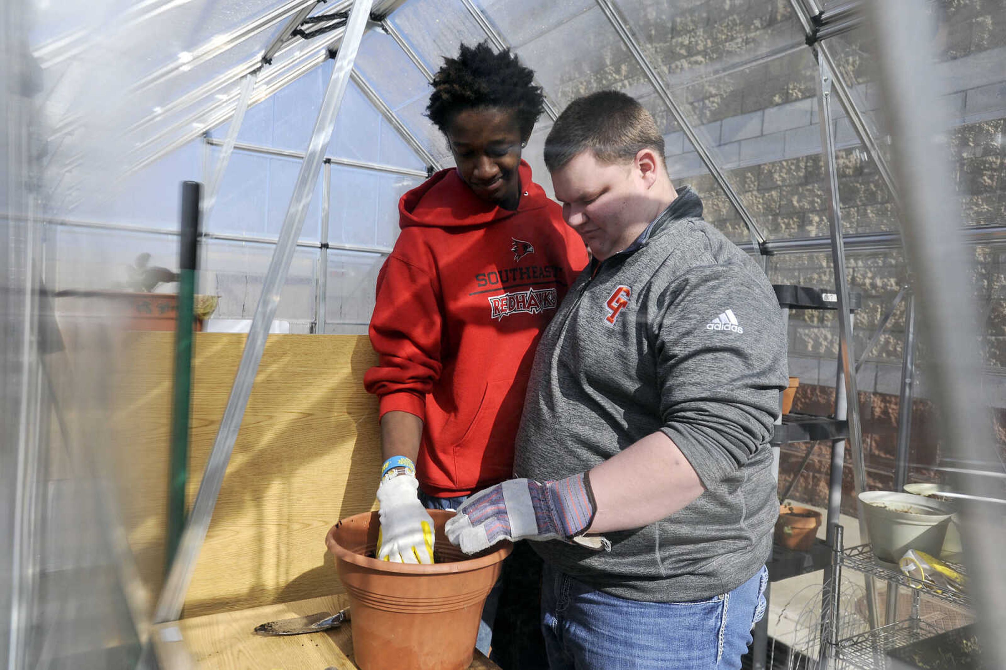 LAURA SIMON ~ lsimon@semissourian.com

Tevontay Hulbert, left, and Garrett Jones plant cilantro seed inside the greenhouse at Central High School in Cape Girardeau, Wednesday, Jan. 27, 2016.