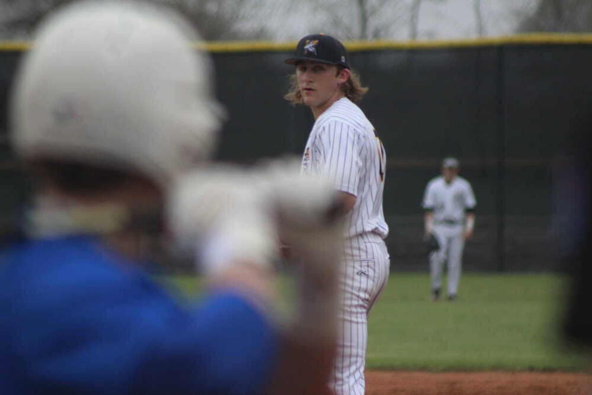 Kennett's Ashton Williams checks the signal and prepares to pitch.