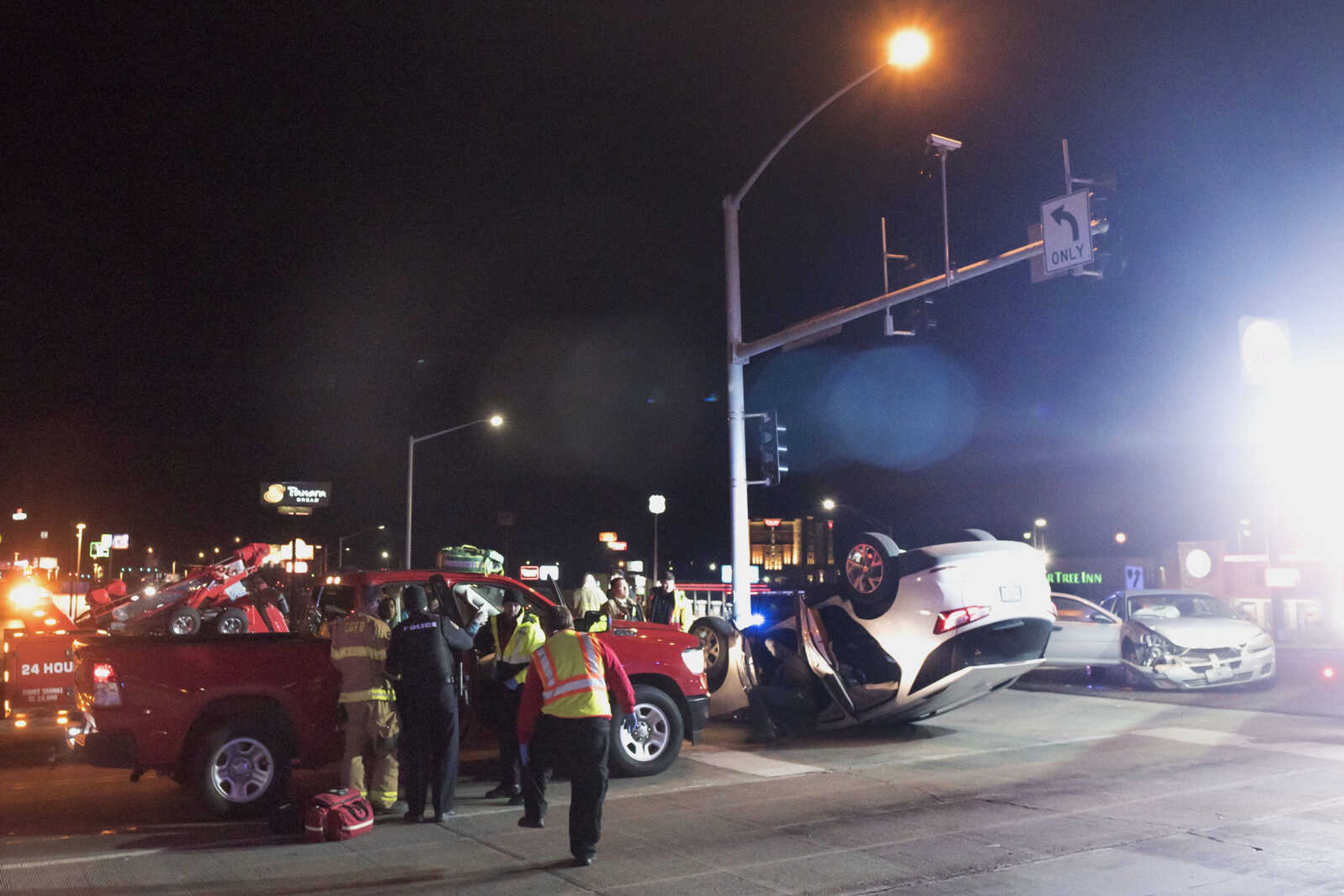 Members of Cape Girardeau's police and fire departments work to clear the scene of a two-car collision in the intersection of Mount Auburn Road and William Street on Monday, Dec. 9, 2019, in Cape Girardeau. At least one person was transported by ambulance from the scene.