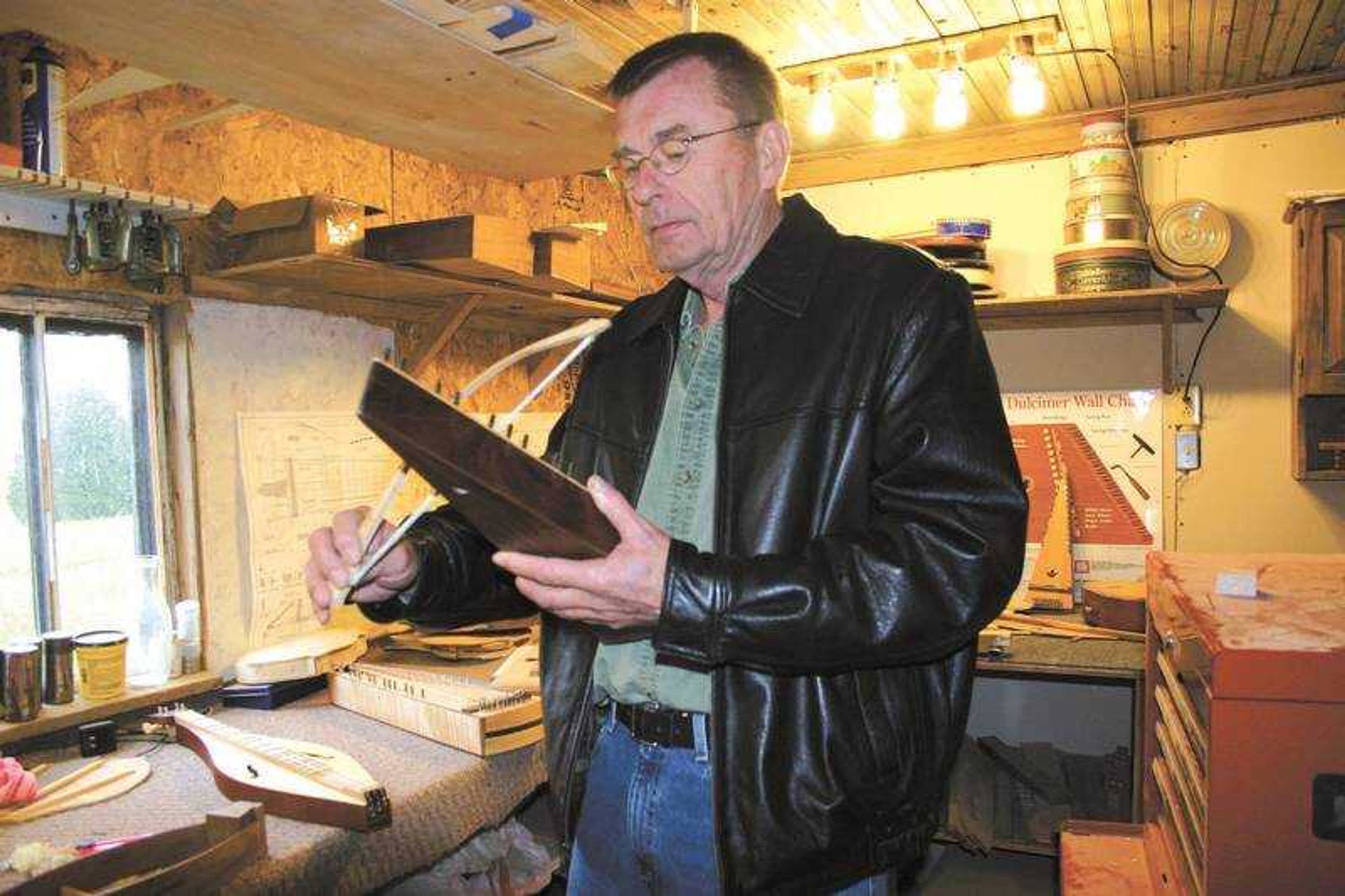 Daily Statesman file photo
Gary Capps was photographed inside his shop showing one of his bowed psalteries in 2006.