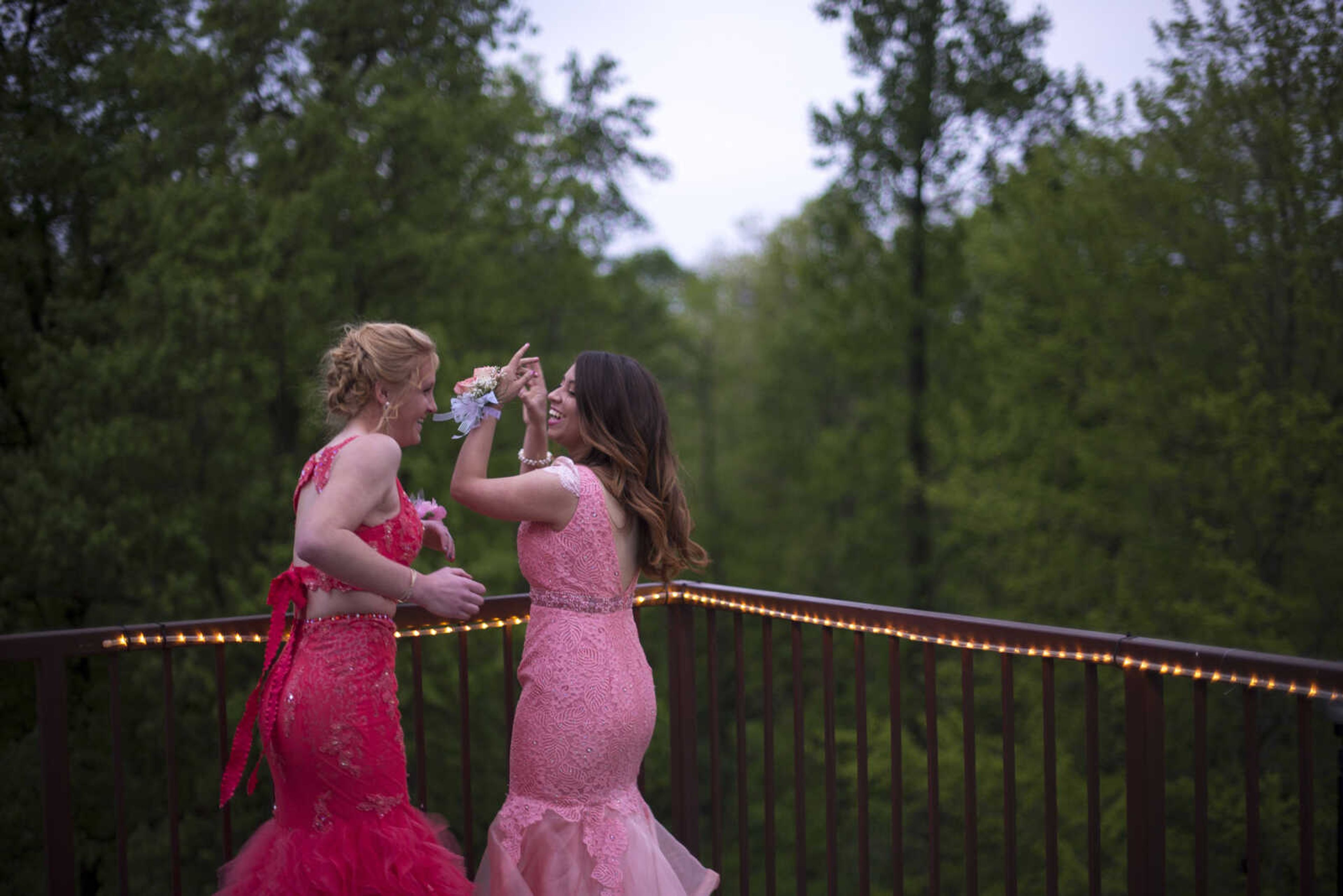 Ashley Fritsche and Analinda Hyatt take photos on the outdoor balcony during the Saxony Lutheran prom Saturday, April 22, 2017 at the Elk's Lodge in Cape Girardeau.