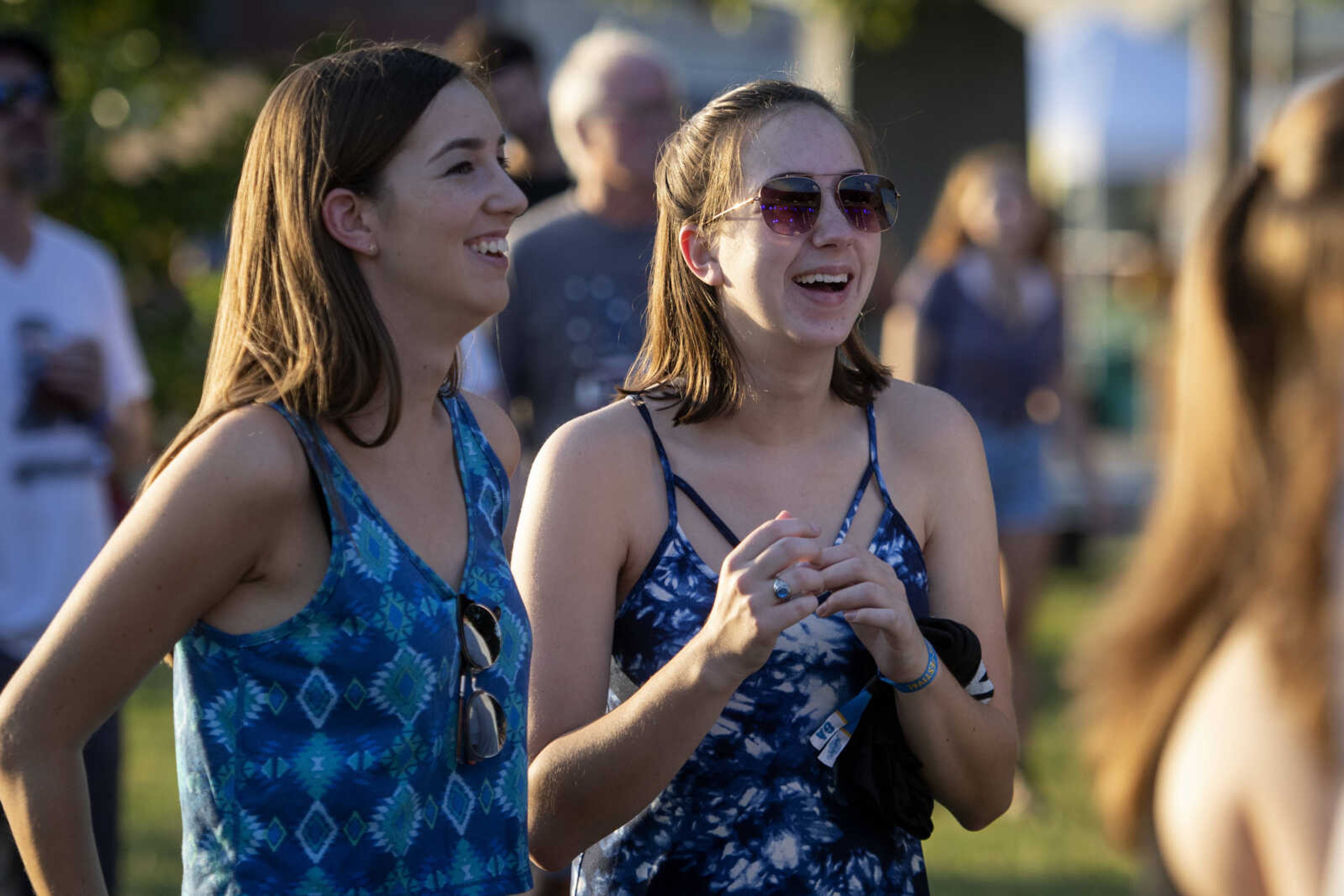 Madeline Siebum, left, and Allyson Siebum, both of St. Louis, watch as Retro City preforms during Shipyard Music and Culture Festival on Friday, Sept. 27, 2019, in Cape Girardeau.