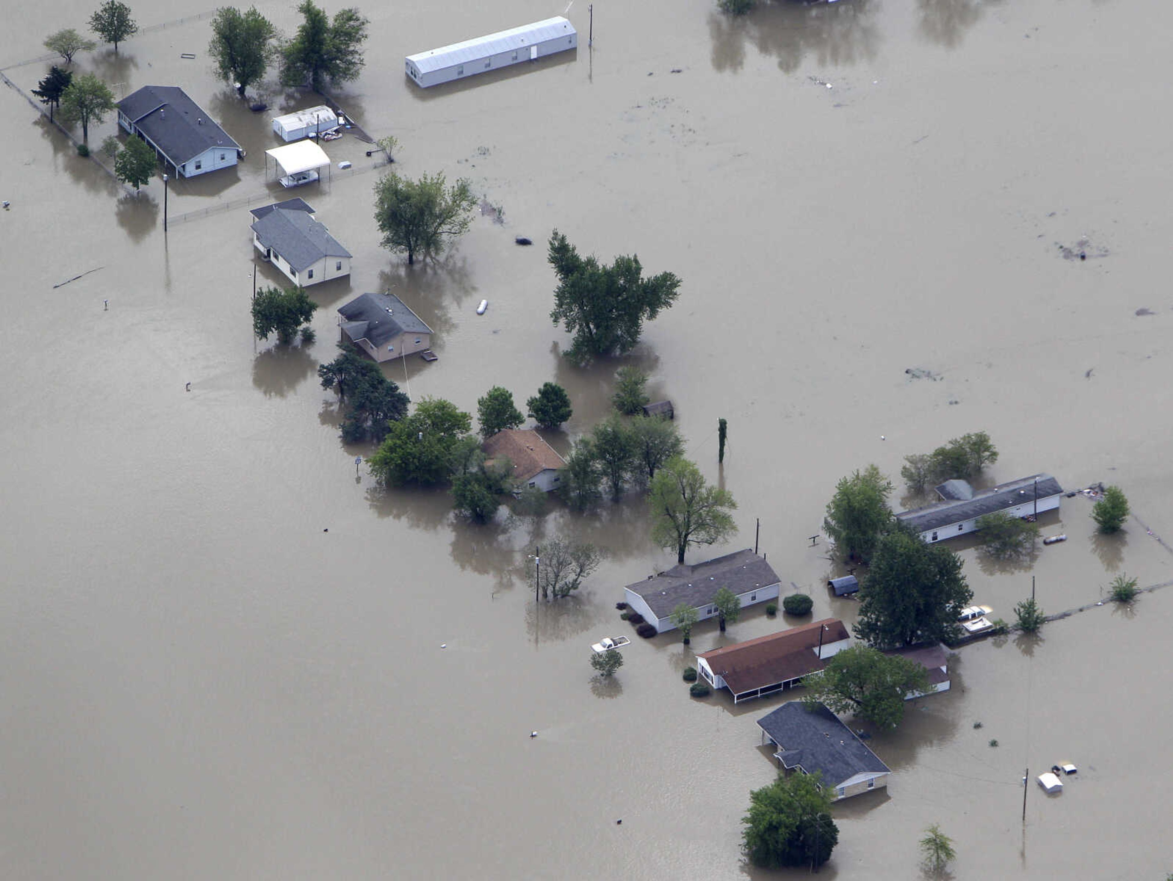 Houses are surrounded by floodwater Tuesday, May 3, 2011, in Pinhook, Mo. The tiny town was flooded when the Army Corps of Engineers' blew a two-mile hole into the Birds Point levee  Monday night in southeast Missouri, flooding 130,000 acres of farmland in Missouri's Mississippi County in an effort to protect nearby Cairo, Ill. (AP Photo/Jeff Roberson)