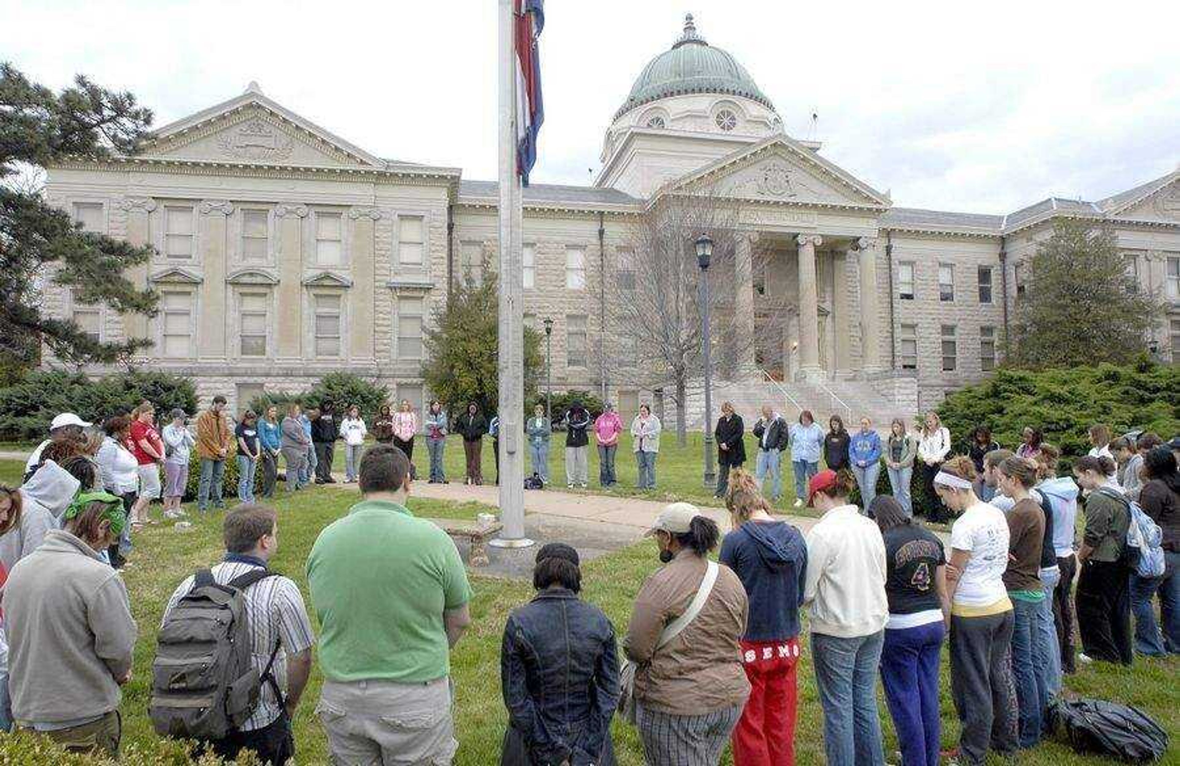 FRED LYNCH ~ flynch@semissourian.com<br>About 60 people gathered for a prayer vigil in front of Academic Hall at Southeast Missouri State University in April 2007 in memory of the slain students at Virginia Tech.