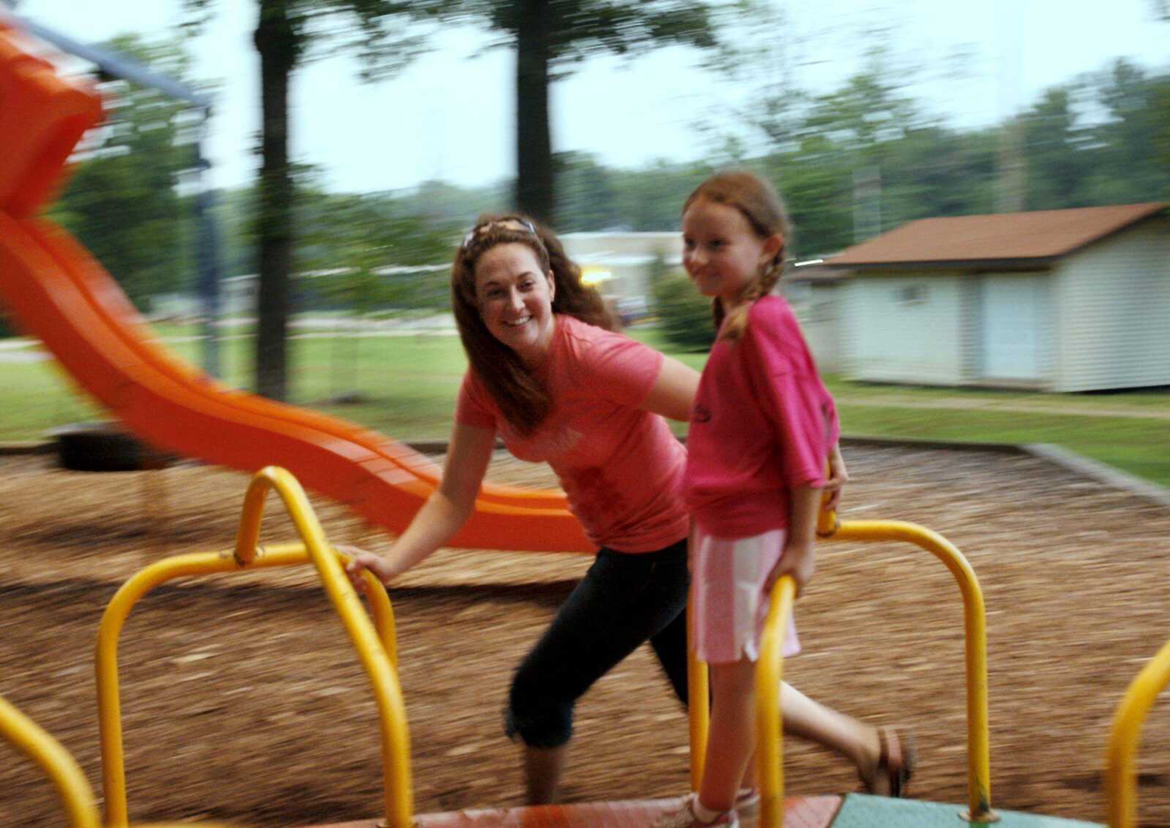 Becky Stein of Cape Girardeau pushes daughter Hallie, 7, on the merry-go-round Thursday at Arena Park. Stein, a teacher from Cape Girardeau, received a heart transplant in November. Colin Osterberg, 16, of Herculaneum, Mo., was the donor. (Elizabeth Dodd)