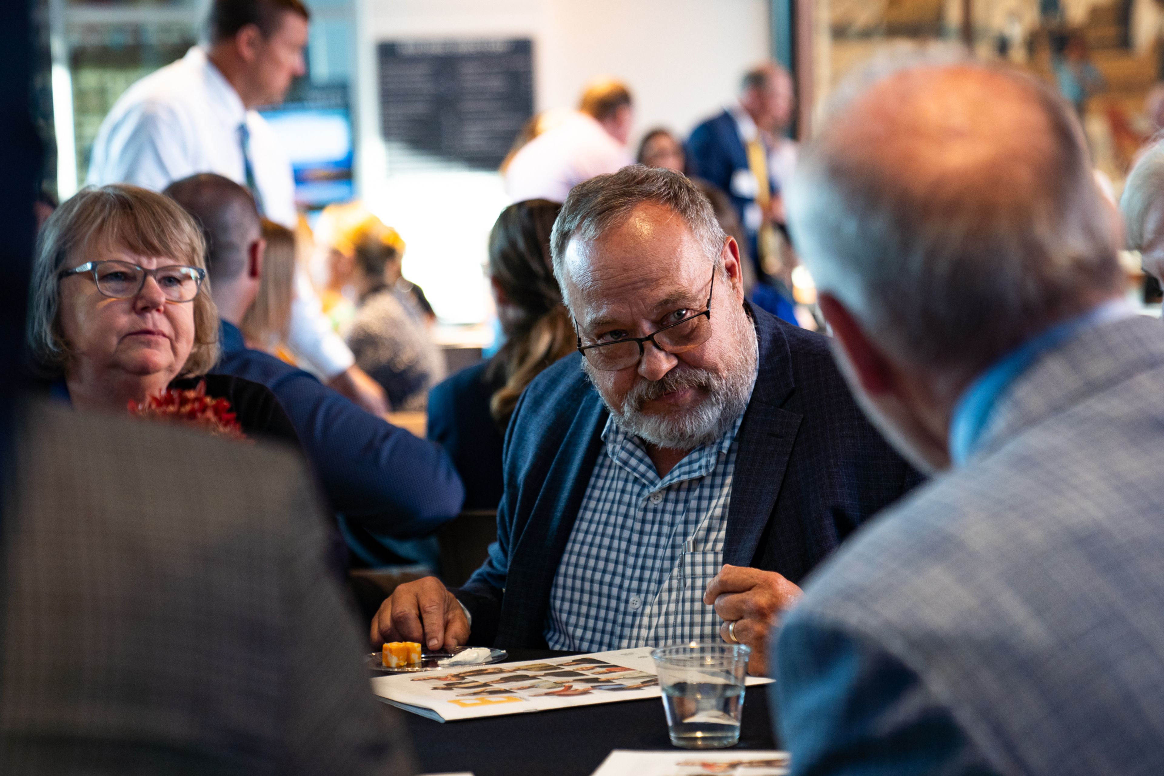 Difference Maker Ed Crowley speaks to attendees at his table before the reception starts at 6 p.m. on Thursday, Sept. 5.