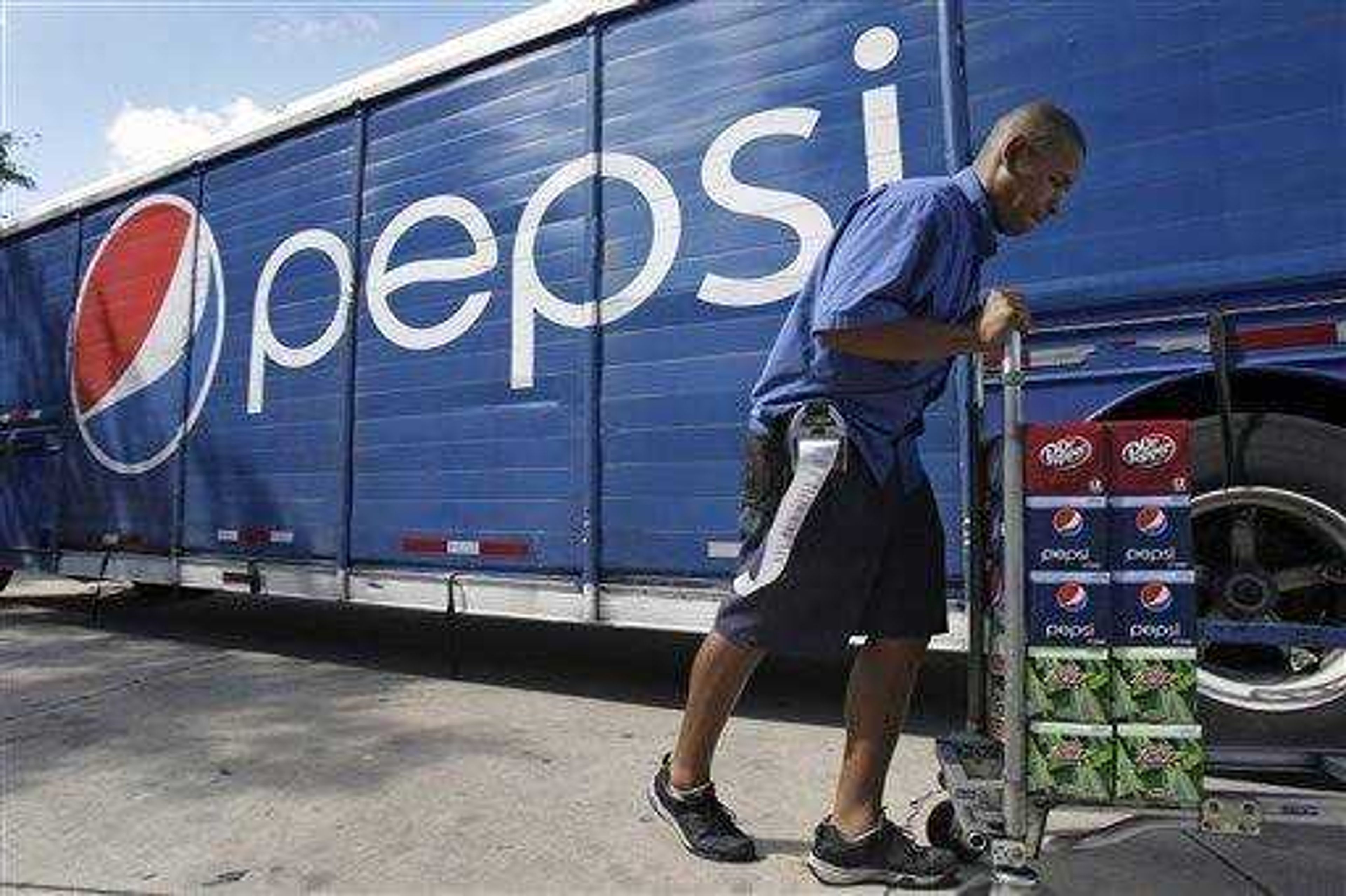 A delivery driver loads Pepsi products on a cart to be delivered to a convenience story in Orlando, Fla., Wednesday. Soft drinks and snack maker PepsiCo said today, its fiscal third-quarter profit rose 9 percent, partly on cost-control efforts.(AP Photo/John Raoux)