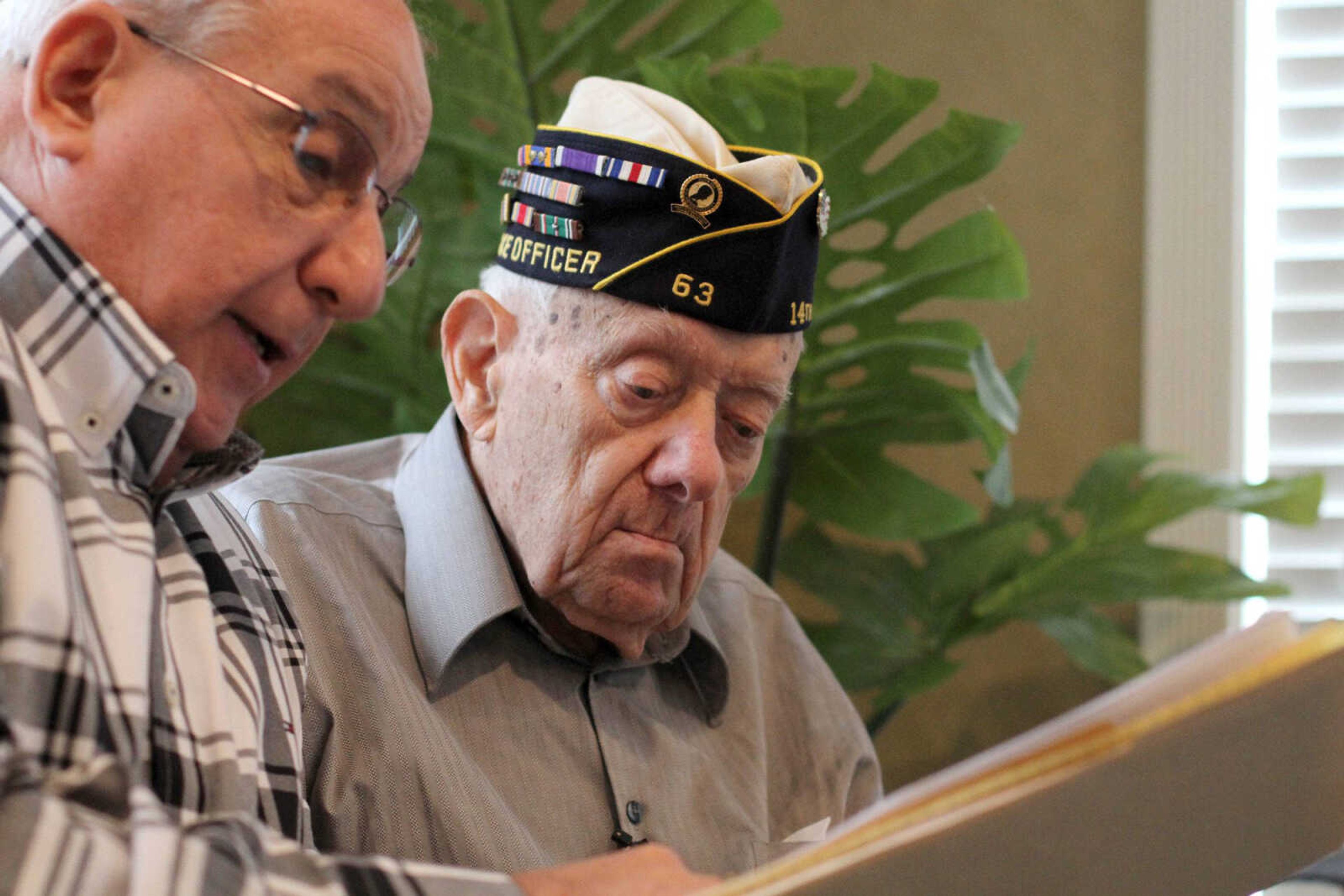 Carl Sherman discusses details with Homer Schnurbusch, a World War II veteran, before an interview Friday for the Missouri Veterans History Project at Capetown Assisted Living in Cape Girardeau. (Glenn Landberg)