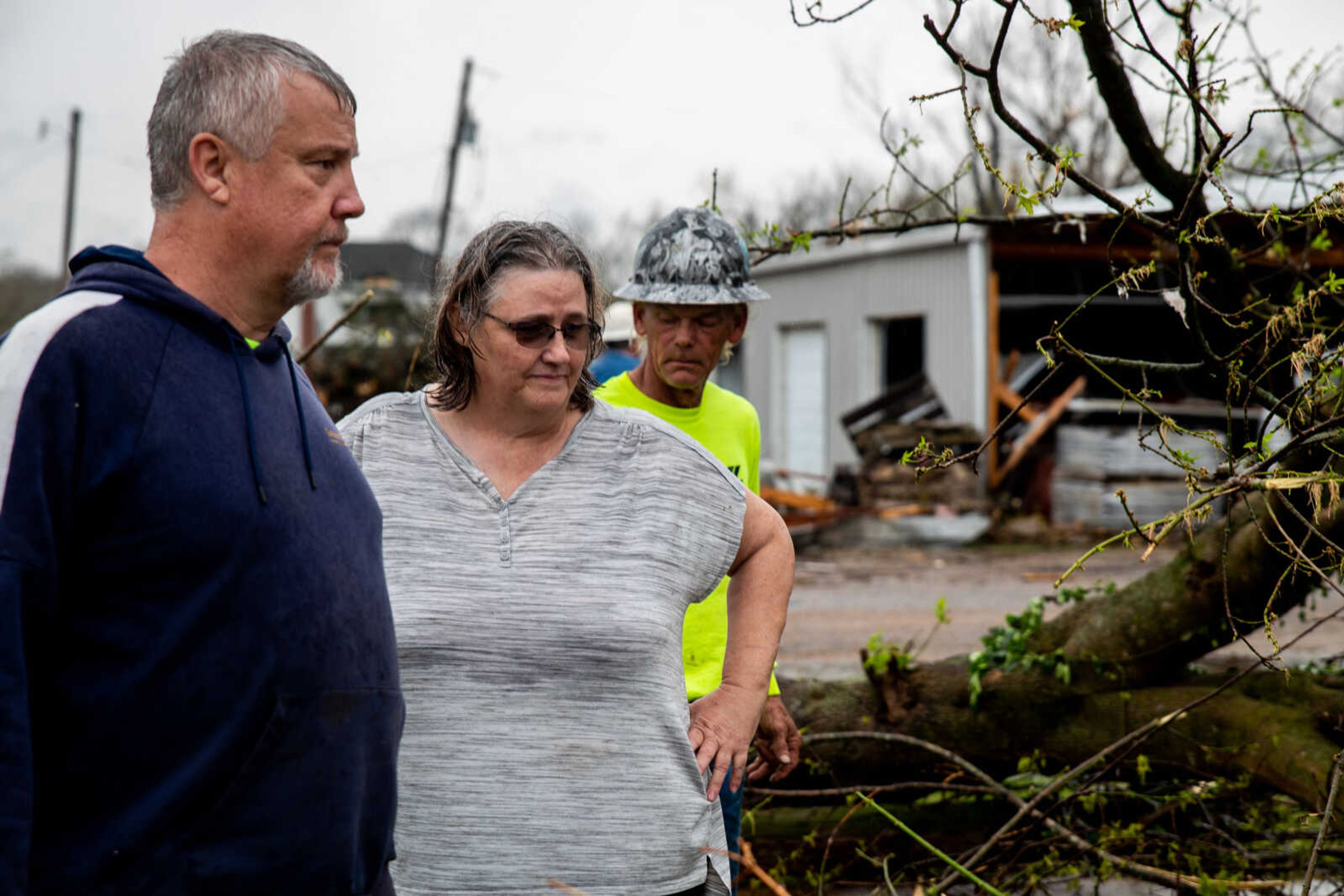 Patty Stanfilld-Seabaugh&nbsp;and her brother Phil Seabaugh look over one of her family's homes, which was completely destroyed by the tornado.