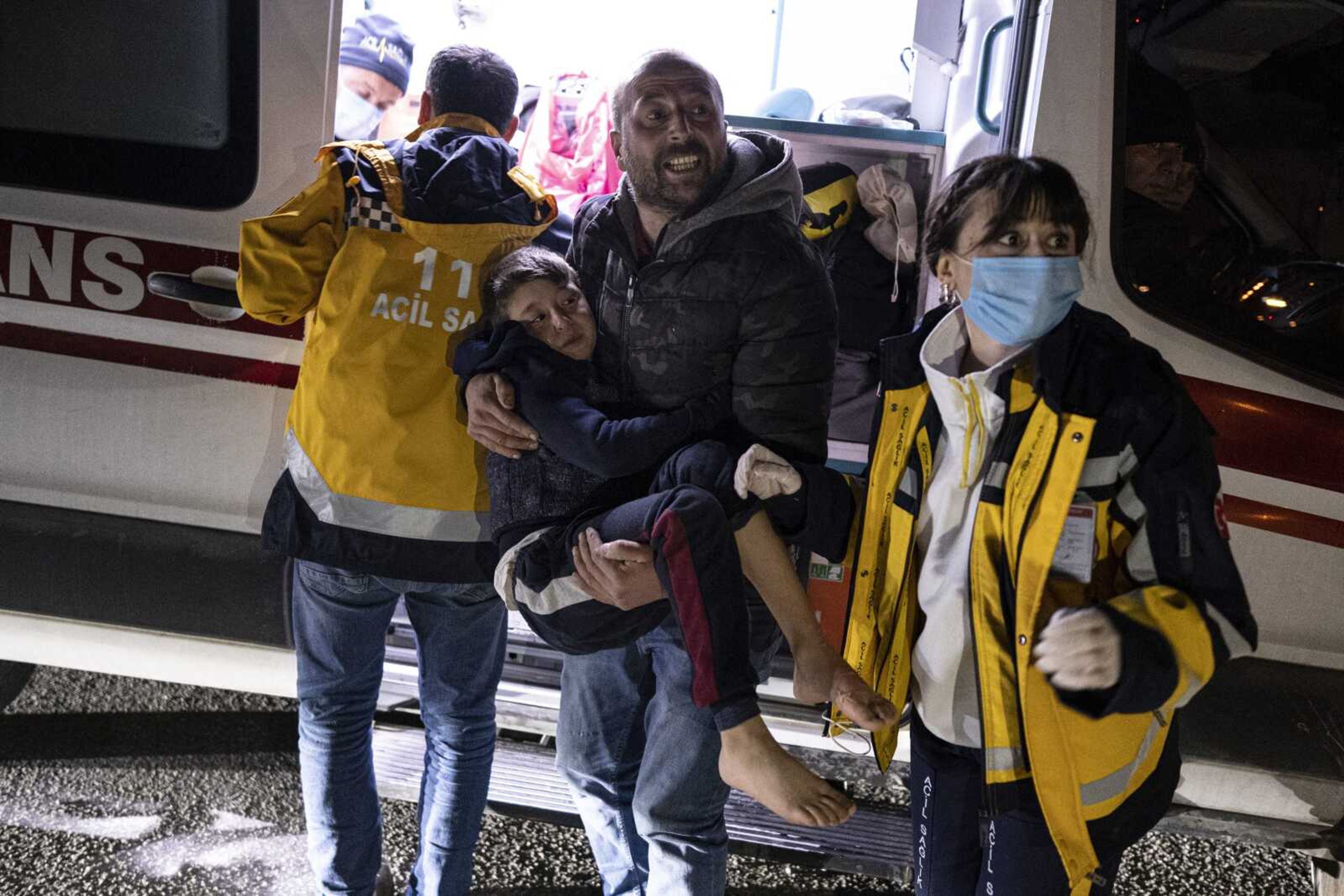 A boy is taken to an ambulance after being injured during the latest earthquake in Hatay, Turkey, Monday, Feb. 20, 2023. A new 6.4 magnitude earthquake on Monday killed three people and injured more than 200 in parts of Turkey that were laid waste two weeks ago by a massive quake that killed tens of thousands. Officials said more buildings collapsed, trapping occupants, and several people were injured in both Turkey and Syria. (Ugur Yildirim/DIA via AP)