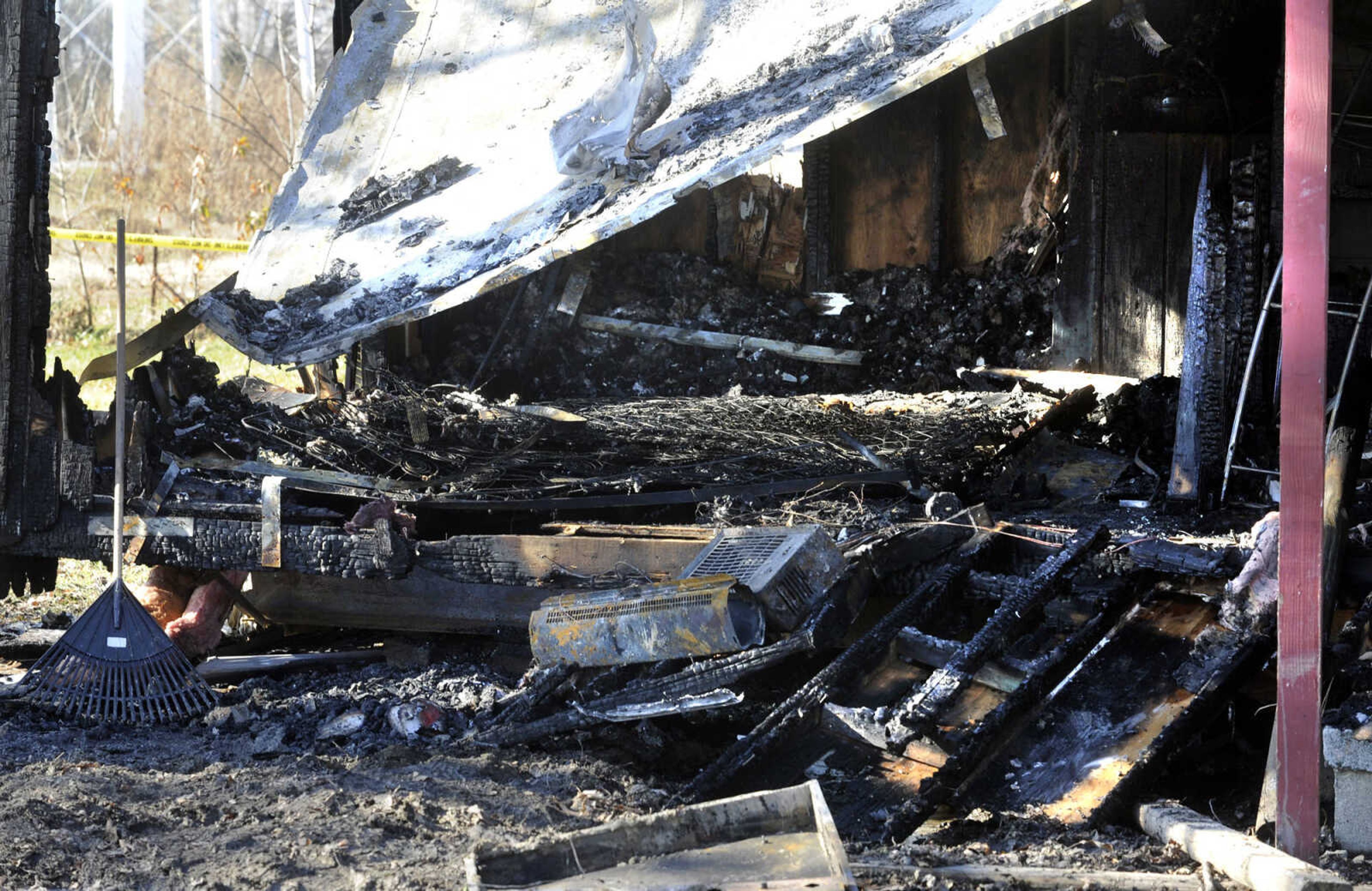 The remains of a mobile home that was destroyed by fire is seen Friday, Nov. 29, 2013 at 466 Penny St. in Allenville. (Fred Lynch)