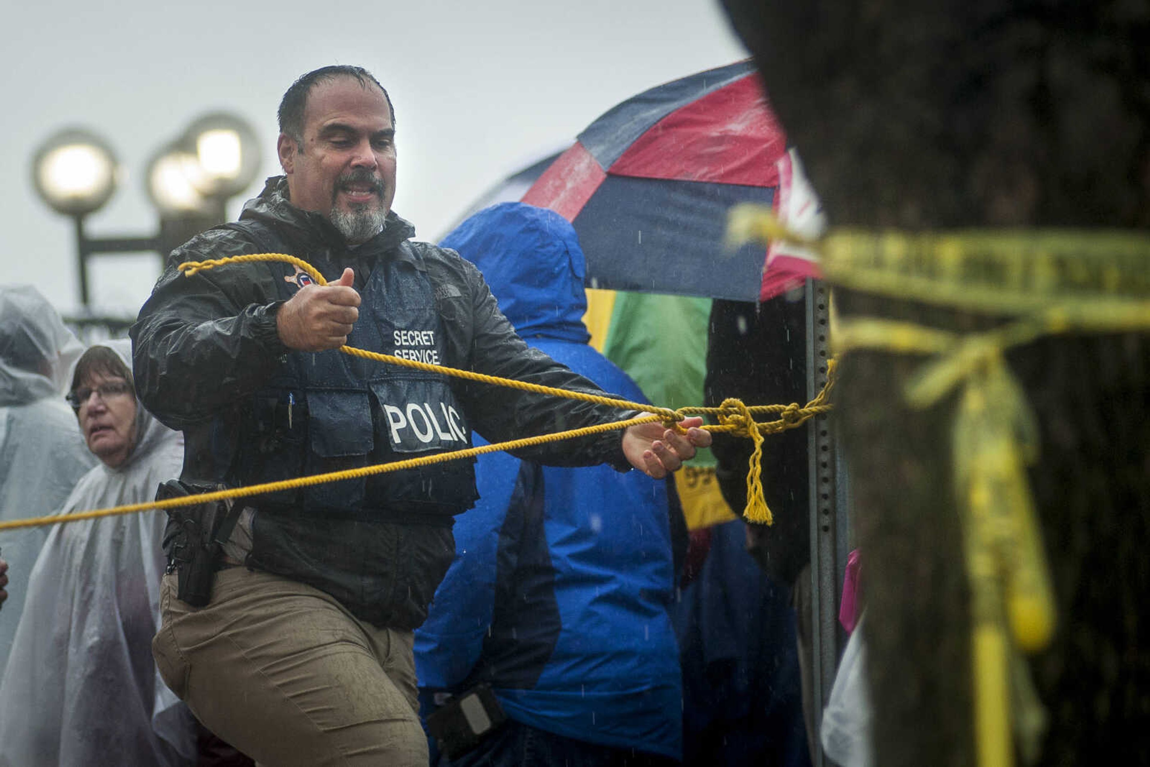 A law enforcement officer ties up rope to control the crowd outside of the Show Me Center Monday, Nov. 5, 2018, in Cape Girardeau.