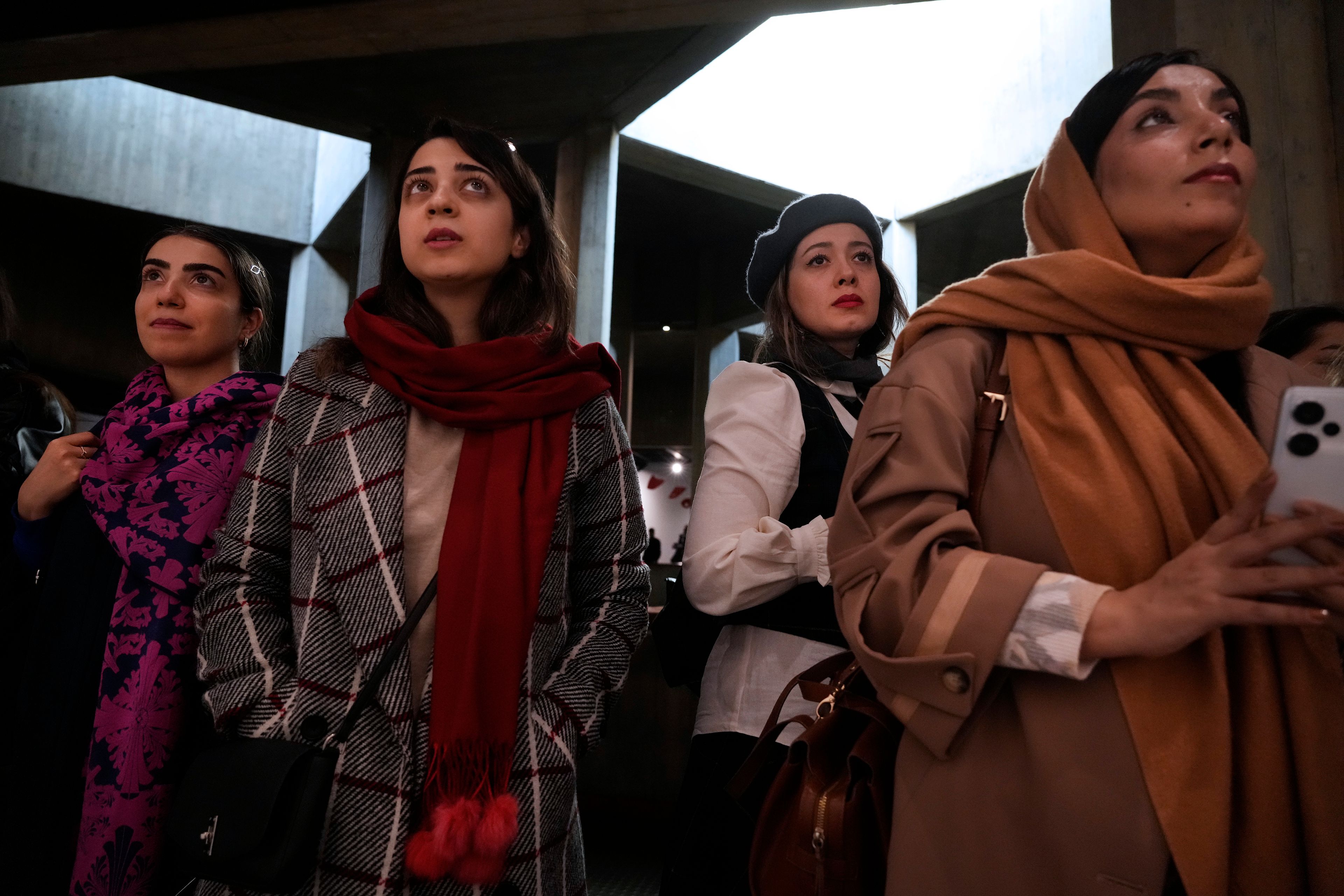 People visit an exhibition titled Eye to Eye which showcases over 120 works by modern world artists as well as Iranian painters at Tehran Museum of Contemporary Art, in Tehran, Thursday, Nov. 21, 2024. (AP Photo/Vahid Salemi)