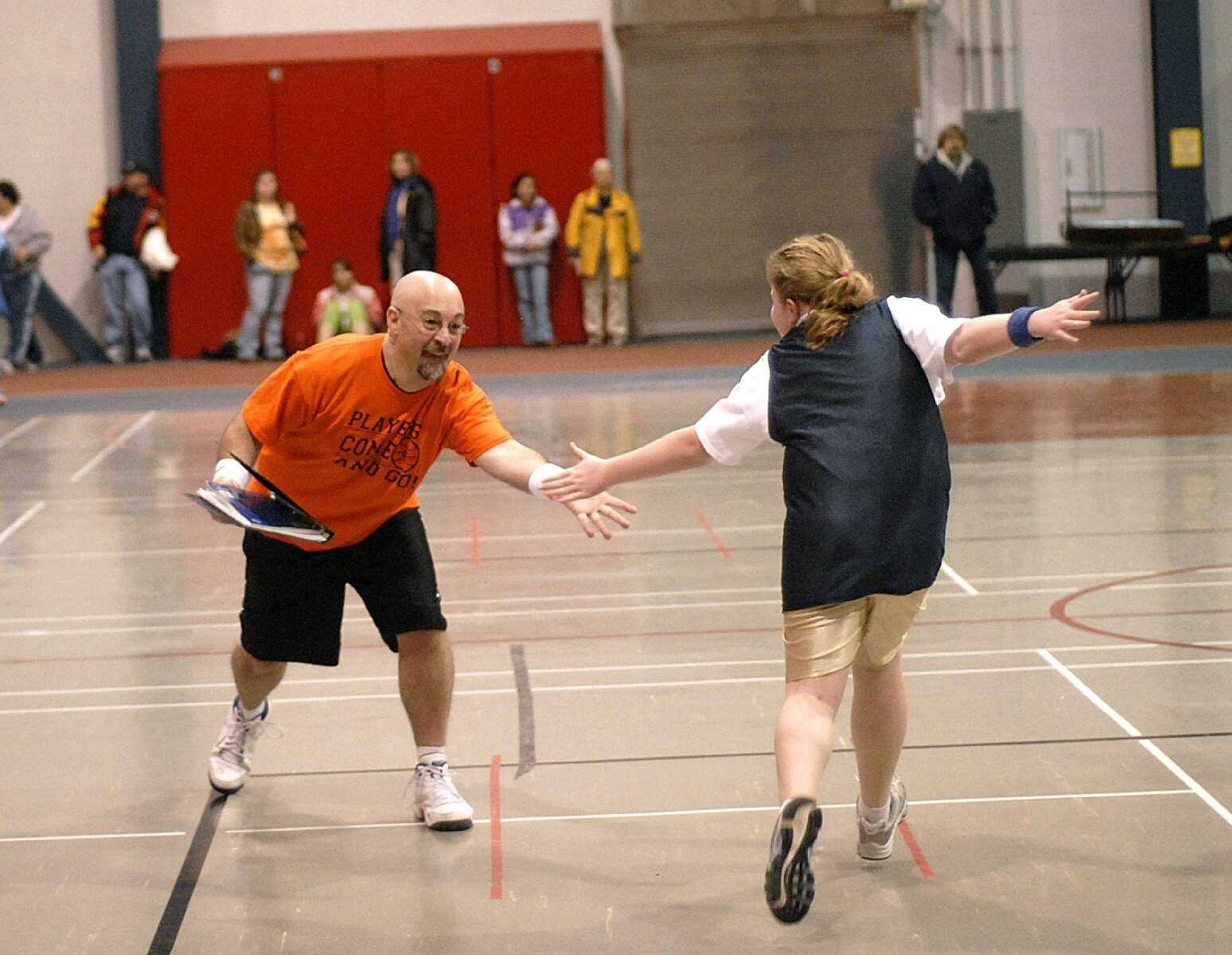 Shannon Aldridge stepped onto the court to slap the hand of Britney Hubbard after she scored a basket Saturday, helping to secure the team's win and their perfect season. (Aaron Eisenhauer)