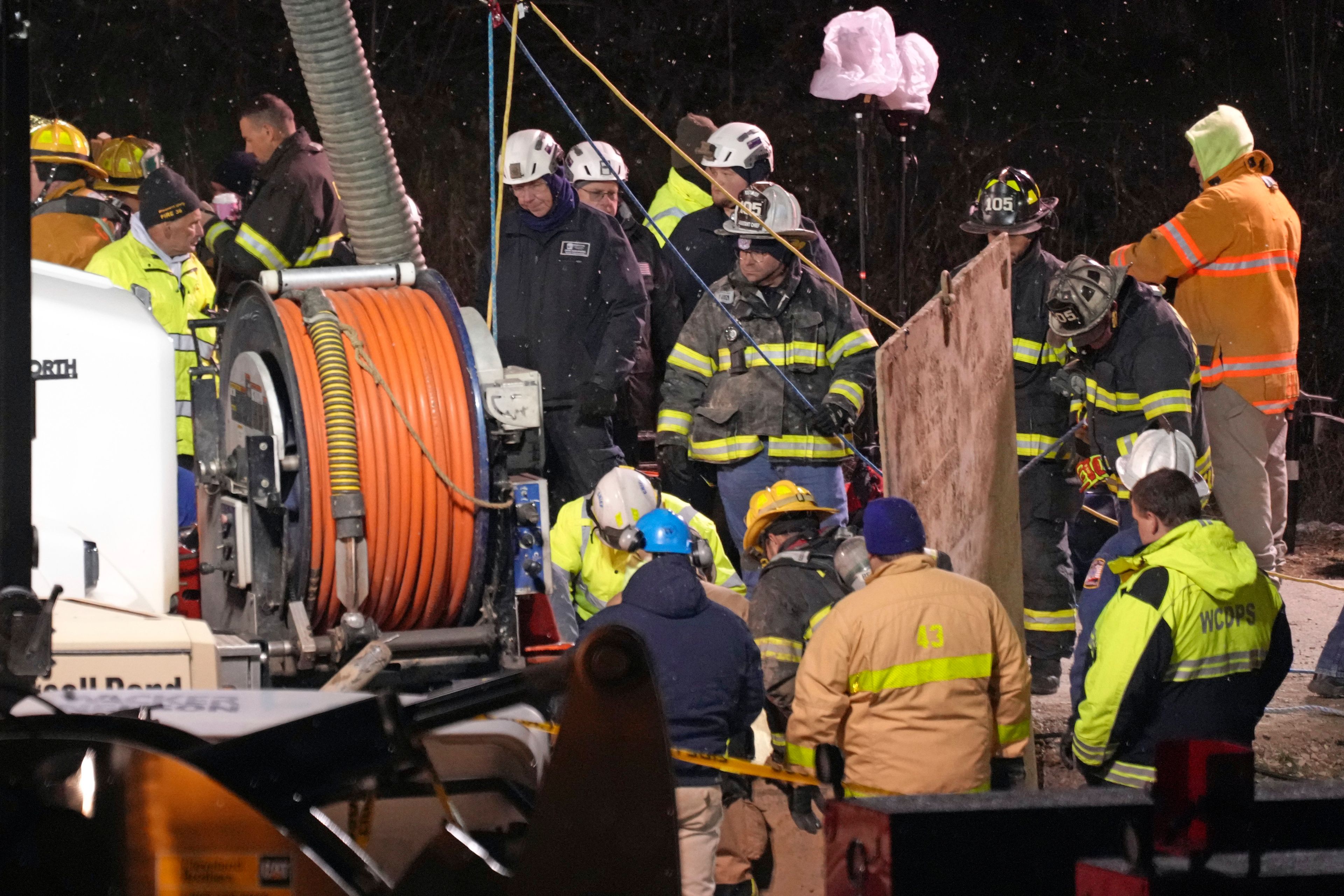 Rescue workers search in a sinkhole for Elizabeth Pollard, who disappeared while looking for her cat, in Marguerite, Pa., Tuesday, Dec. 3, 2024. (AP Photo/Gene J. Puskar)