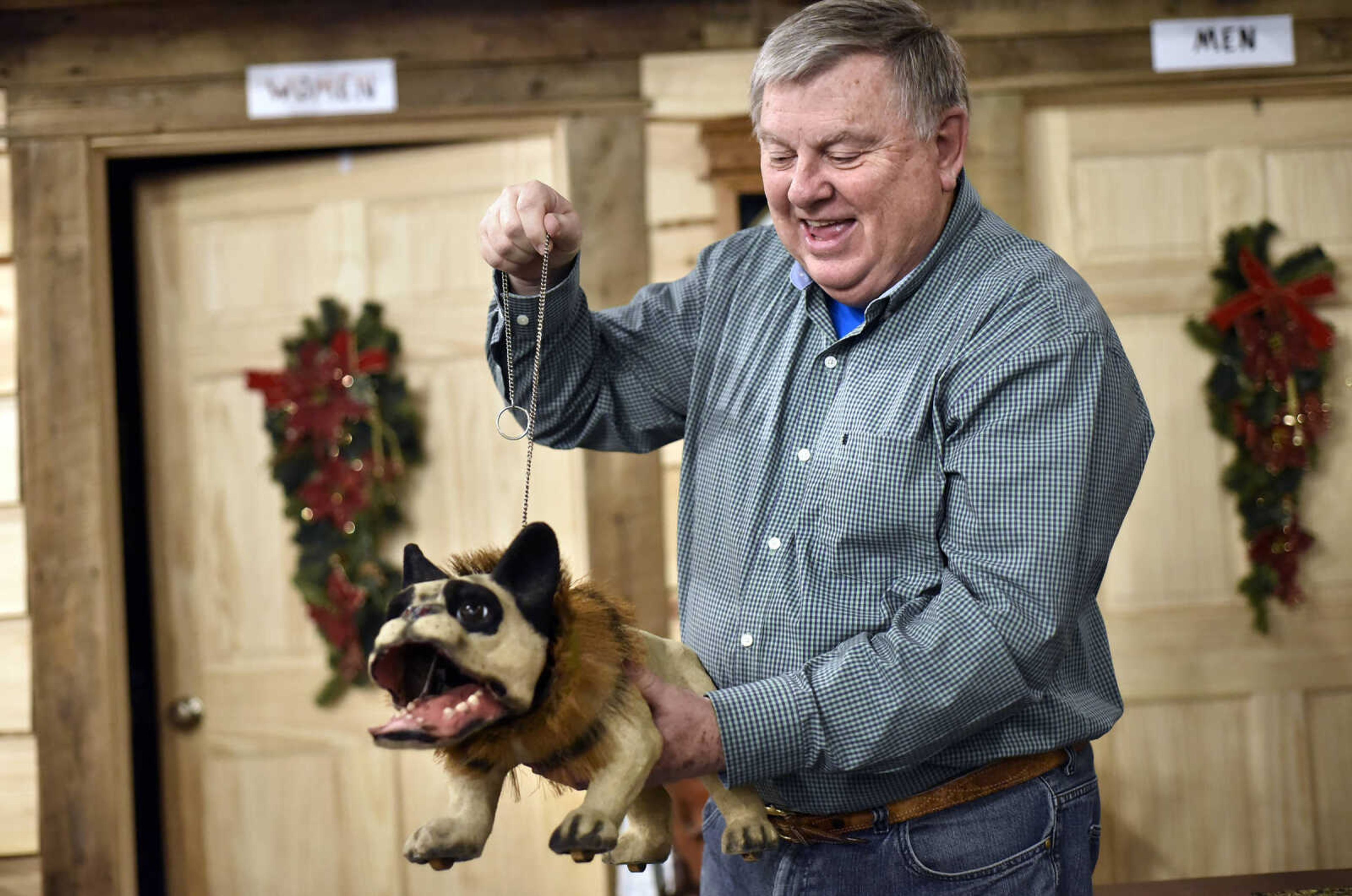 Harlan Smothers plays with an old toy dog Fat Chance General Store in Cape Girardeau County.