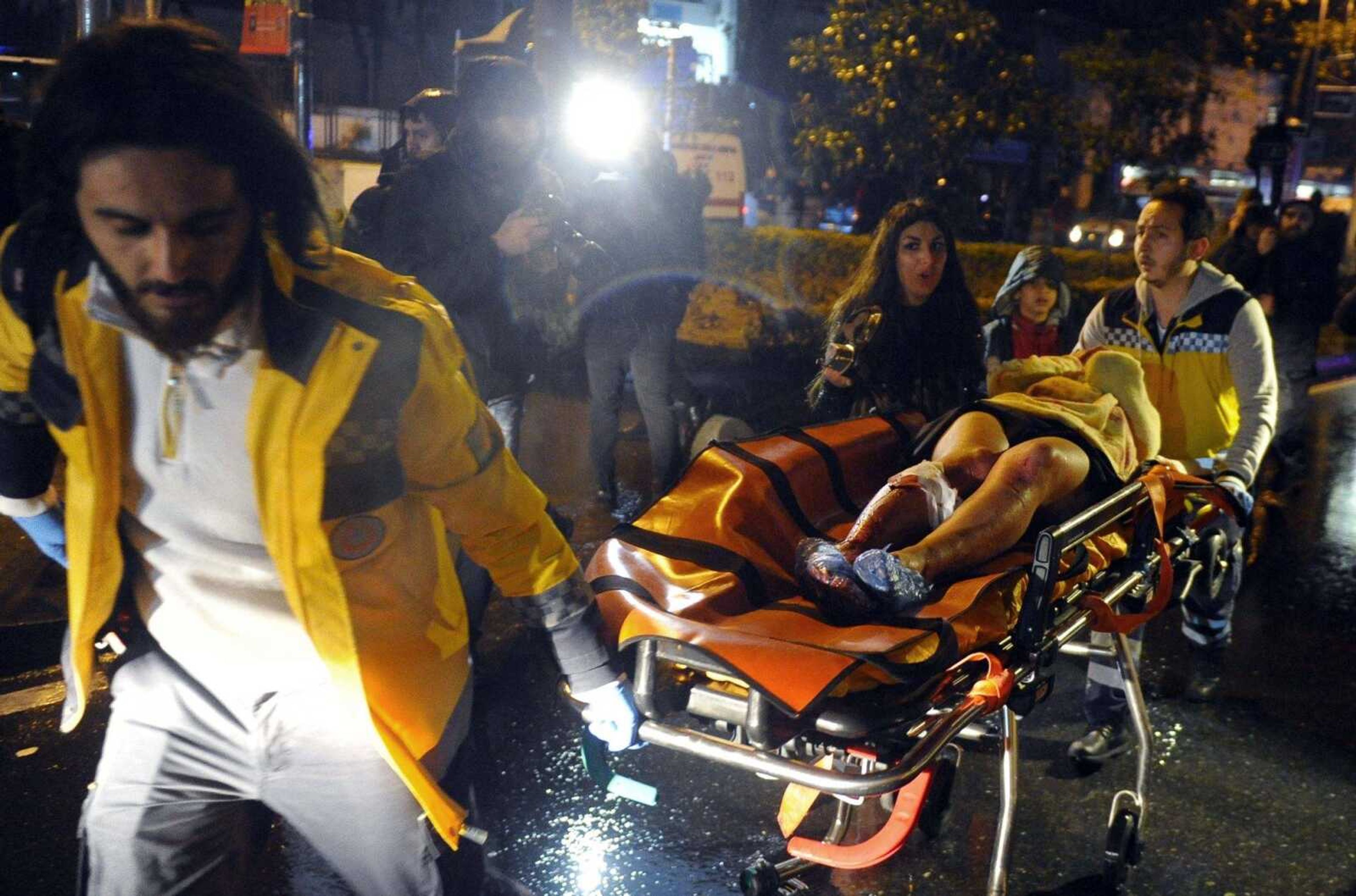 Medics carry a wounded person at the scene after an attack Sunday at a popular nightclub in Istanbul.