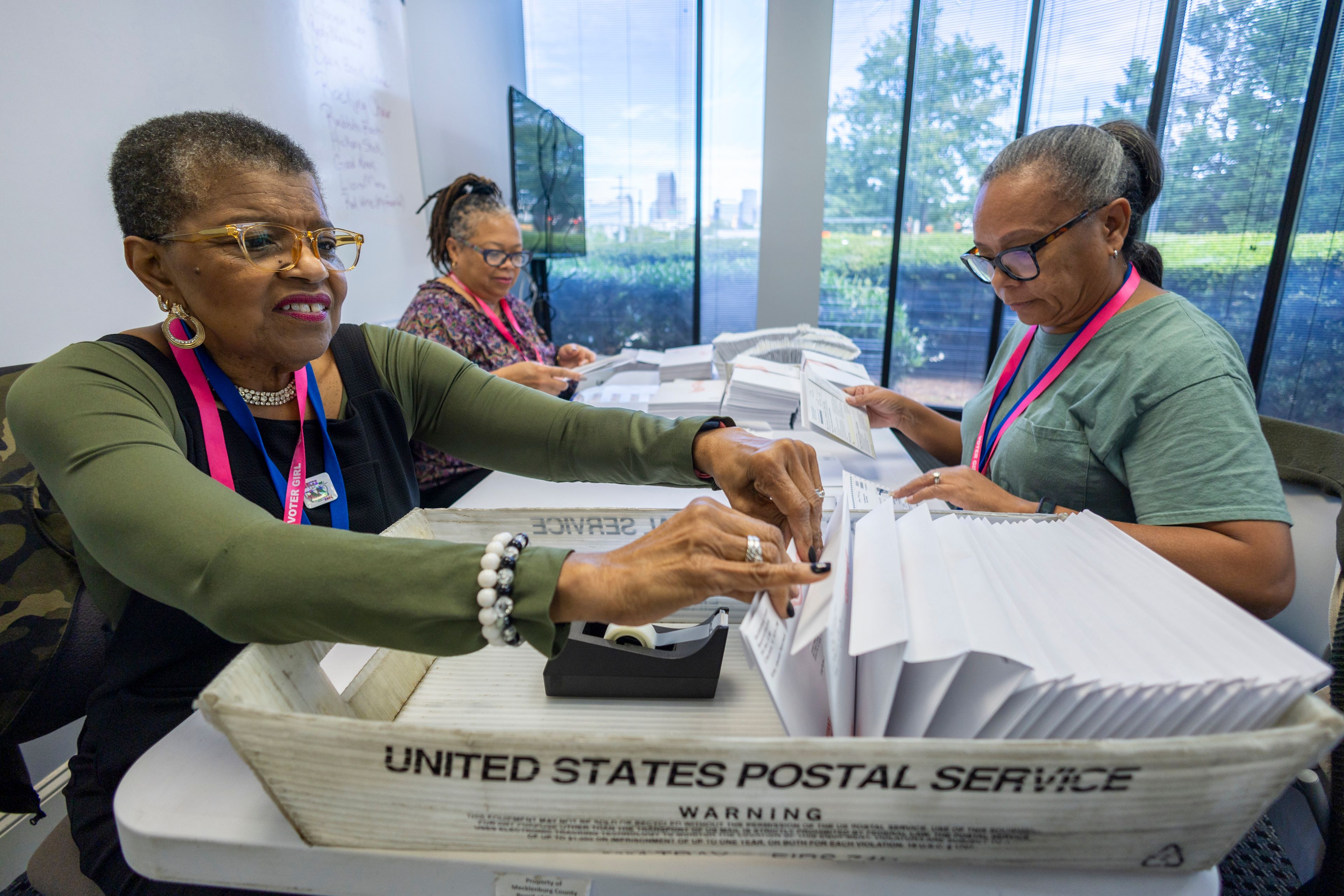 FILE - From left, Carol Hamilton, Cristo Carter and Cynthia Huntley prepare ballots to be mailed at the Mecklenburg County Board of Elections in Charlotte, N.C., Sept. 5, 2024. (AP Photo/Nell Redmond, File)