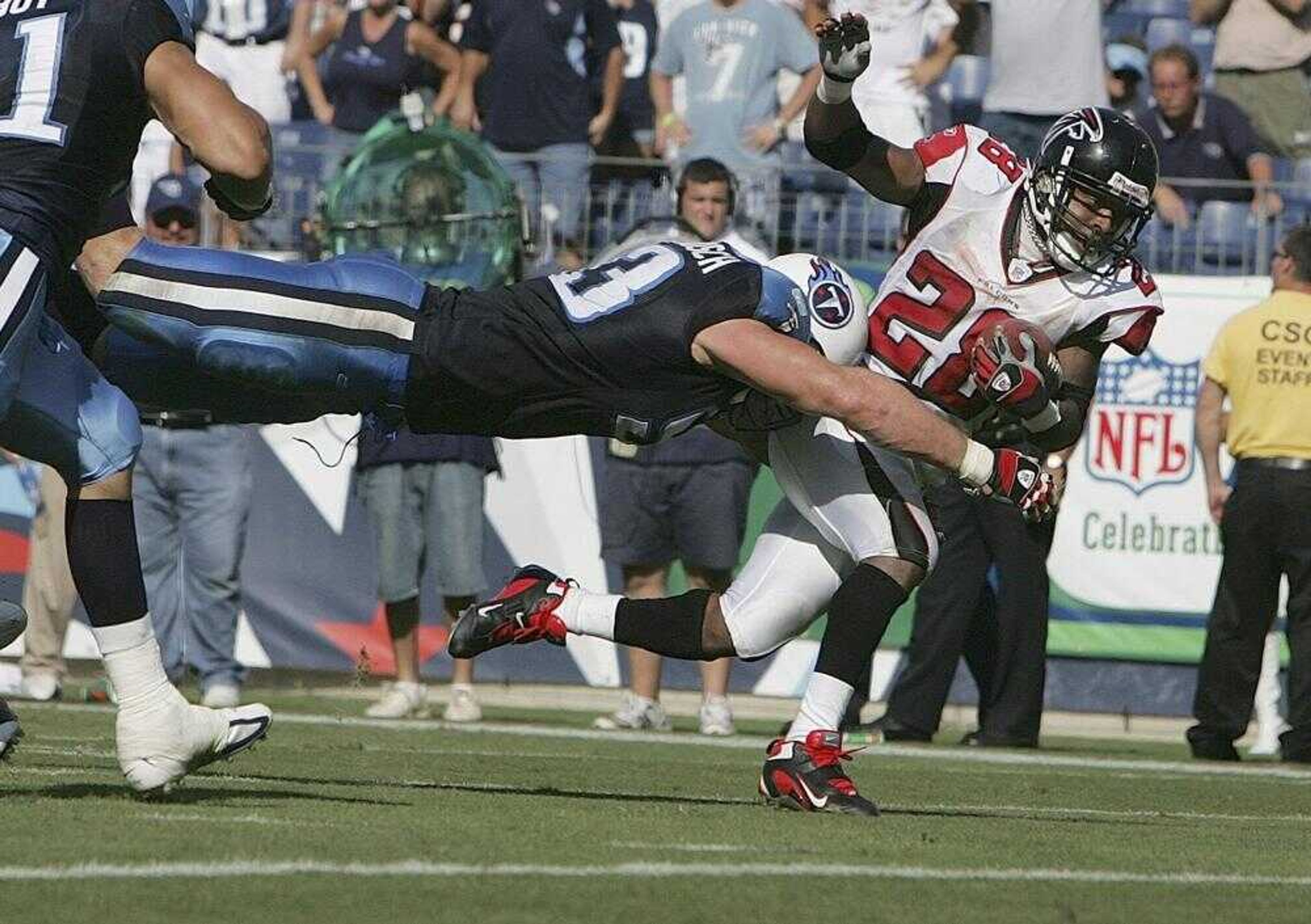 Tennessee Titans defensive end Kyle Vanden Bosch stopped Atlanta Falcons running back Warrick Dunn just short of the end zone late in the fourth quarter Sunday in Nashville, Tenn. The Titans won 20-13. (BRANT SANDERLIN ~ Atlanta Journal &amp; Constitution)