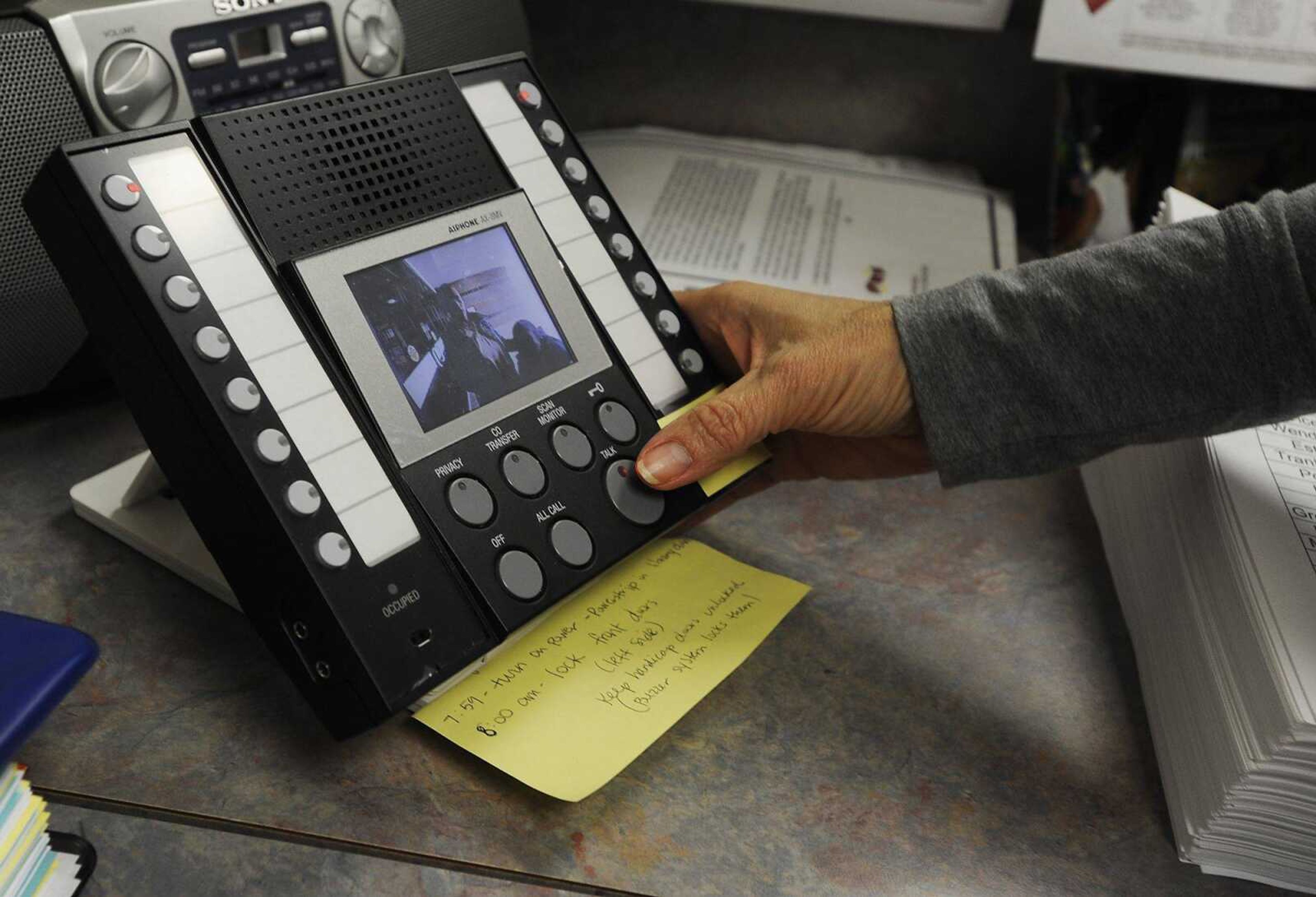 Secretary Cindi Crites buzzes in Sharon Clark using a camera and intercom system, Tuesday, Feb. 26, at the front entrance of South Elementary School in Jackson. Anyone wanting to enter the building must identify themselves before being allowed in. Crites was dropping off Andre Hill, 8, a third grade student at the school. (ADAM VOGLER)