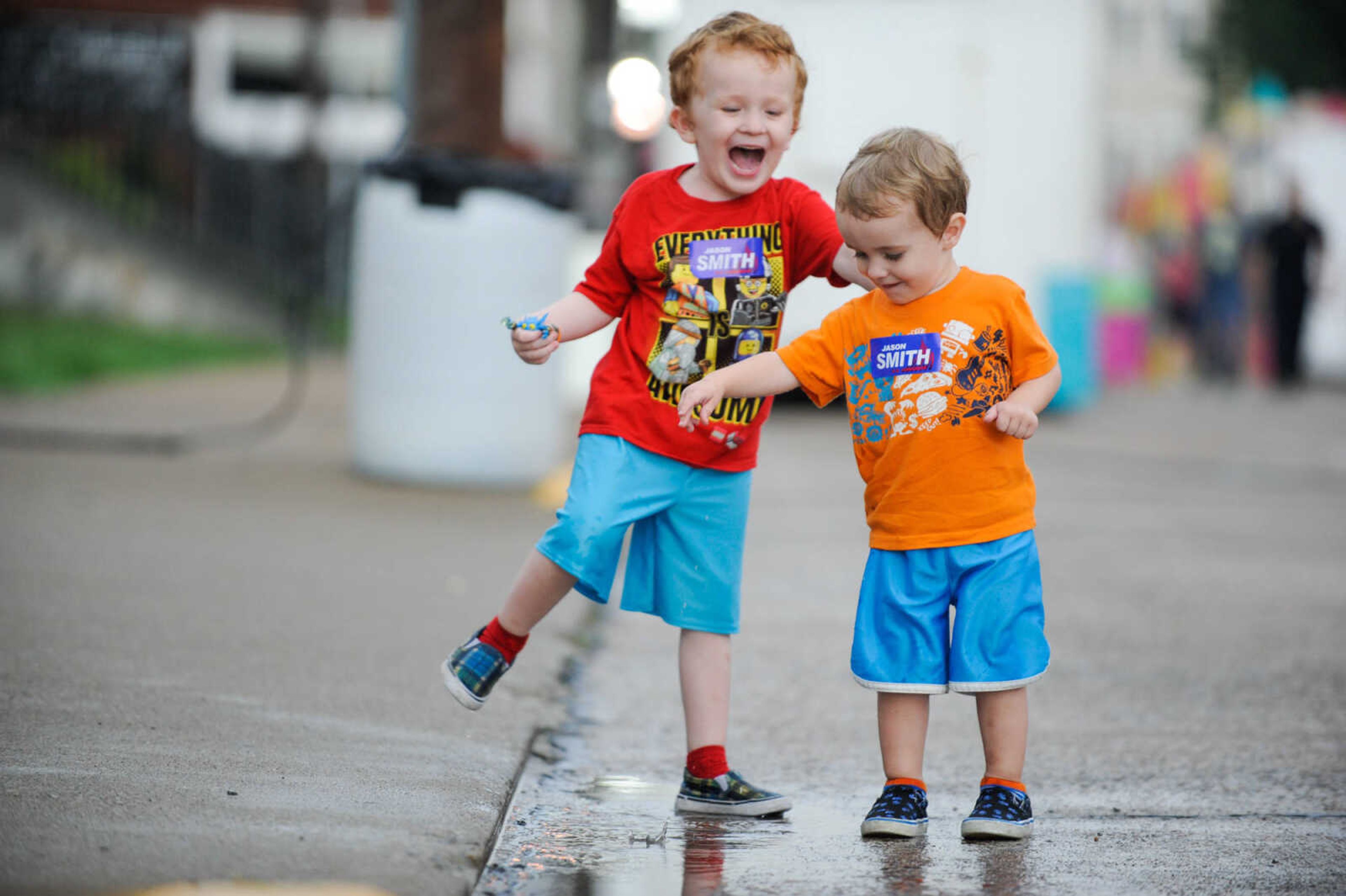 GLENN LANDBERG ~ glandberg@semissourian.com

Arthur and Oliver Tuschhoff splash around in a puddle during a rainy opening day of the 108th Homecomers in Jackson, Tuesday, July 26, 2016. Homecomers runs through Saturday in uptown Jackson.