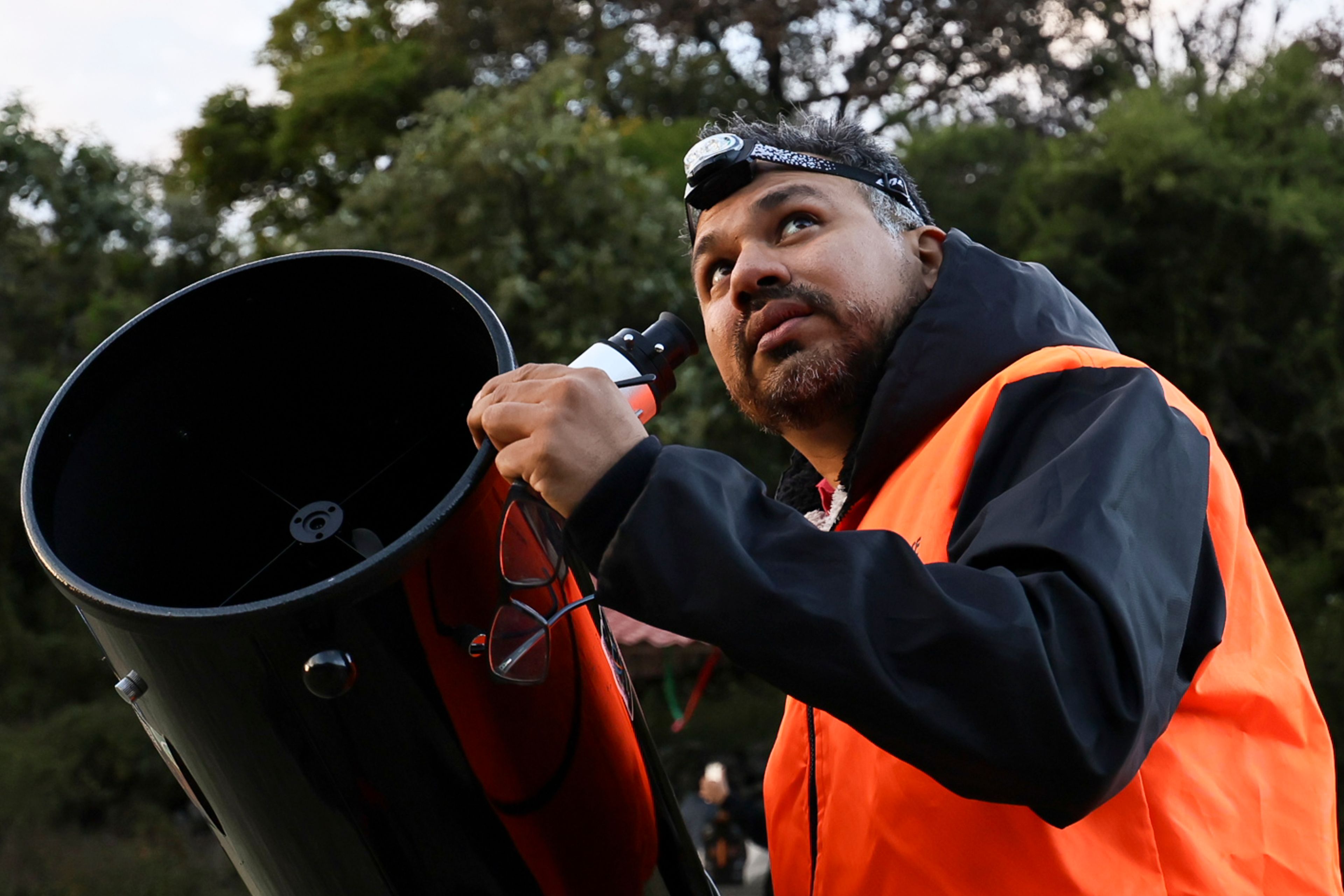 Juan Carlos Hernandez, the president of Queretaro’s Astronomical Society, sets up a telescope before a stargazing and comet-watching gathering at Joya-La Barreta Ecological Park in Queretaro, Mexico, Saturday, Oct. 19, 2024. (AP Photo/Ginnette Riquelme)